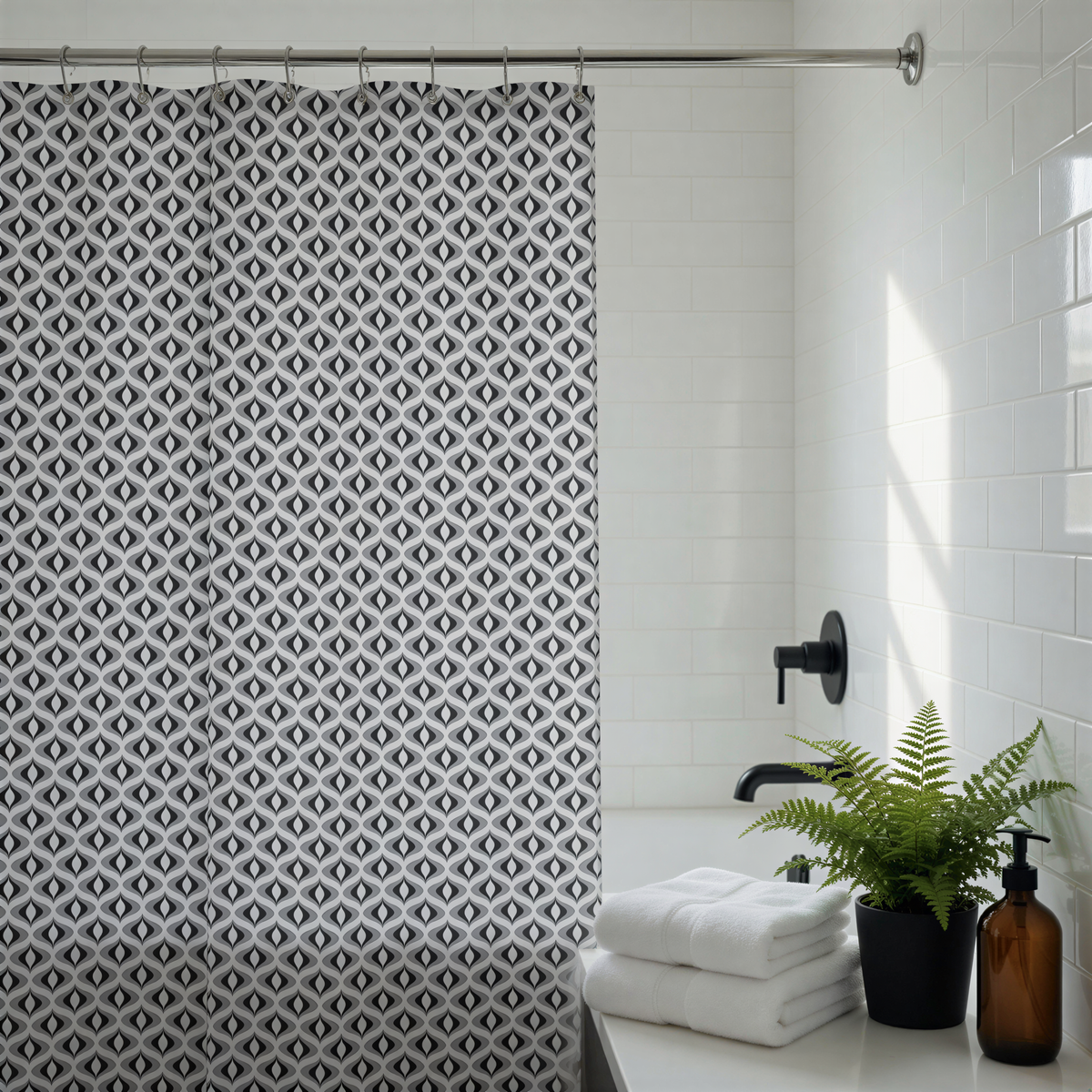 a bathroom with a black and white patterned shower curtain, a white countertop with folded towels, a potted plant, and a brown bottle.