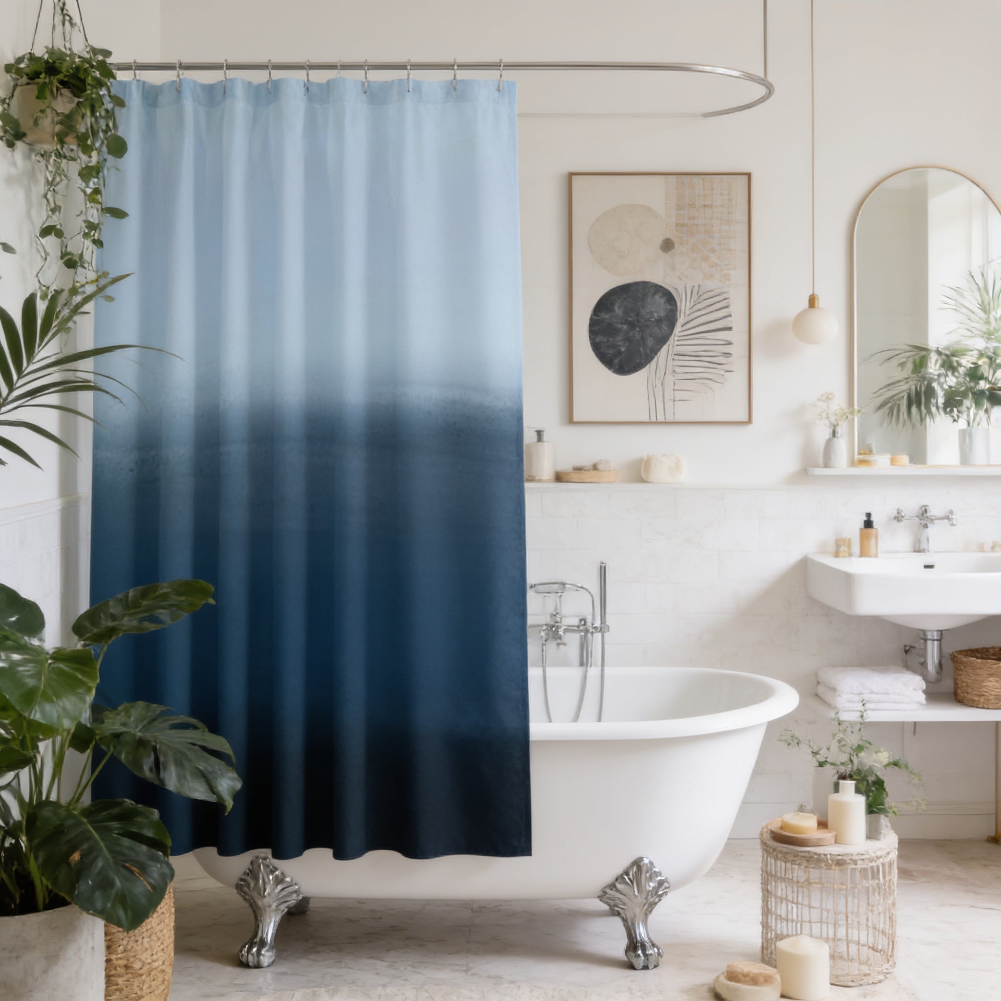 a modern bathroom with a white freestanding bathtub, a blue ombre shower curtain, and a large mirror. The bathroom is decorated with potted plants and has a minimalist design.