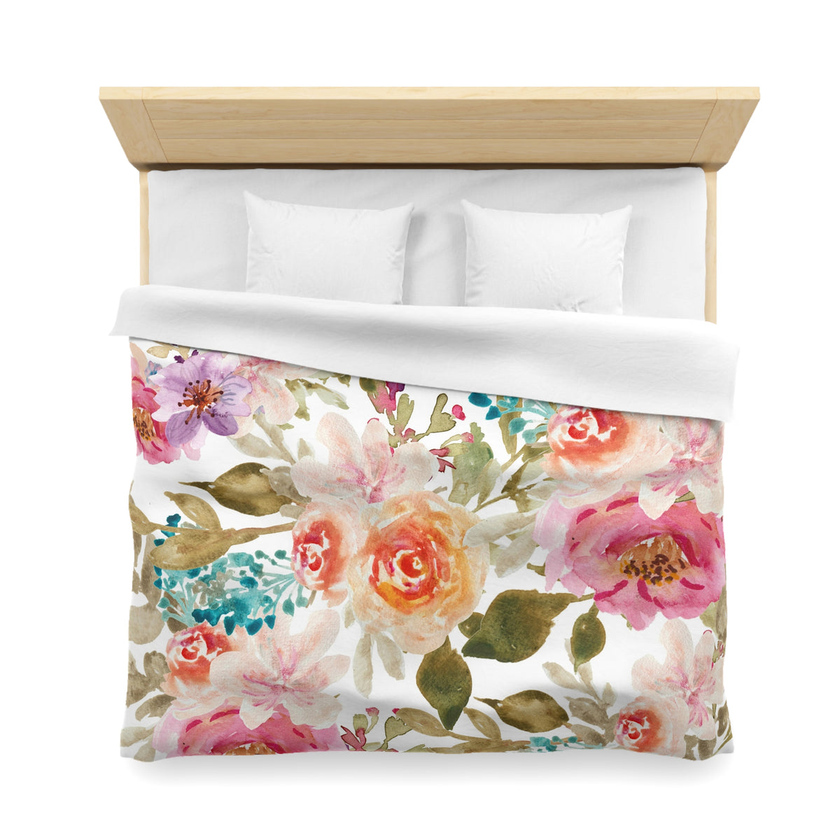 a bed with a floral print duvet cover and pillows.