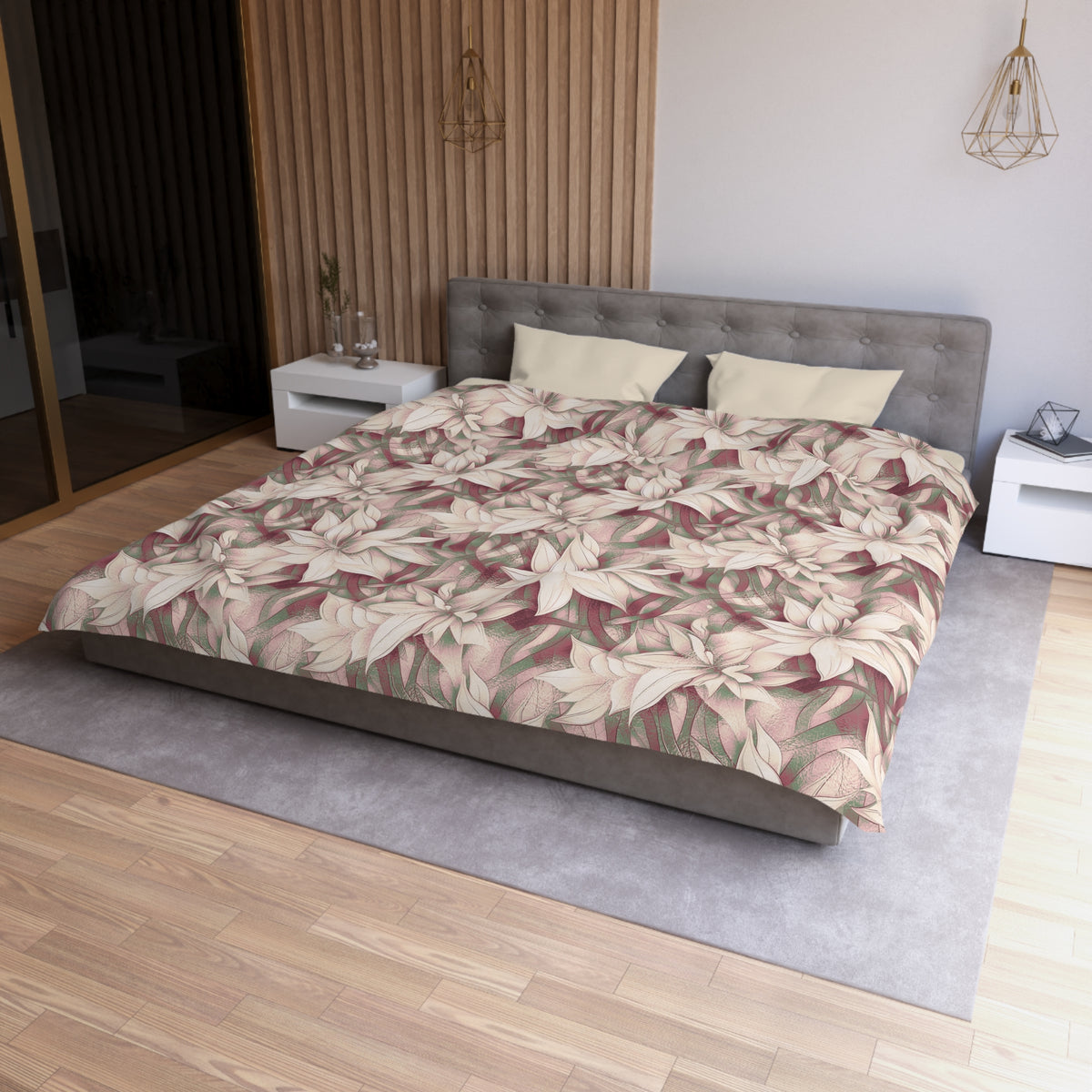 a modern bedroom with a large bed, a gray headboard, and a floral patterned comforter. The room has a wooden floor and white nightstands on either side of the bed. There is a pendant light hanging above the bed, and a vase on one of the nightstands. The overall design and decor of the room create a serene and inviting atmosphere.