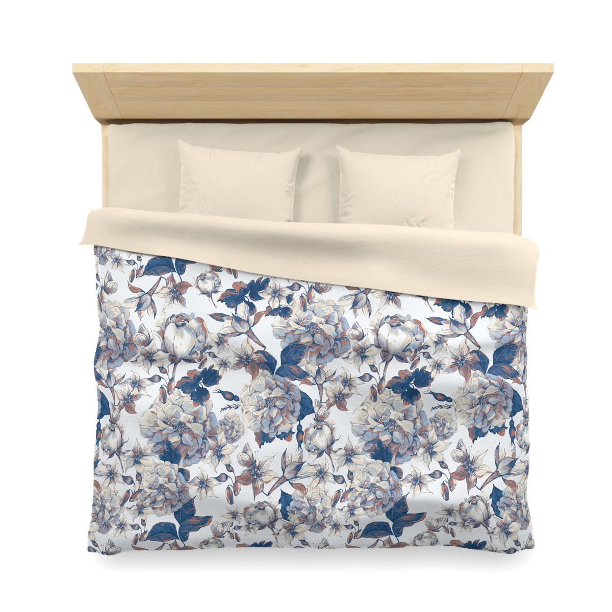 a neatly made bed with a floral patterned comforter and pillows.
