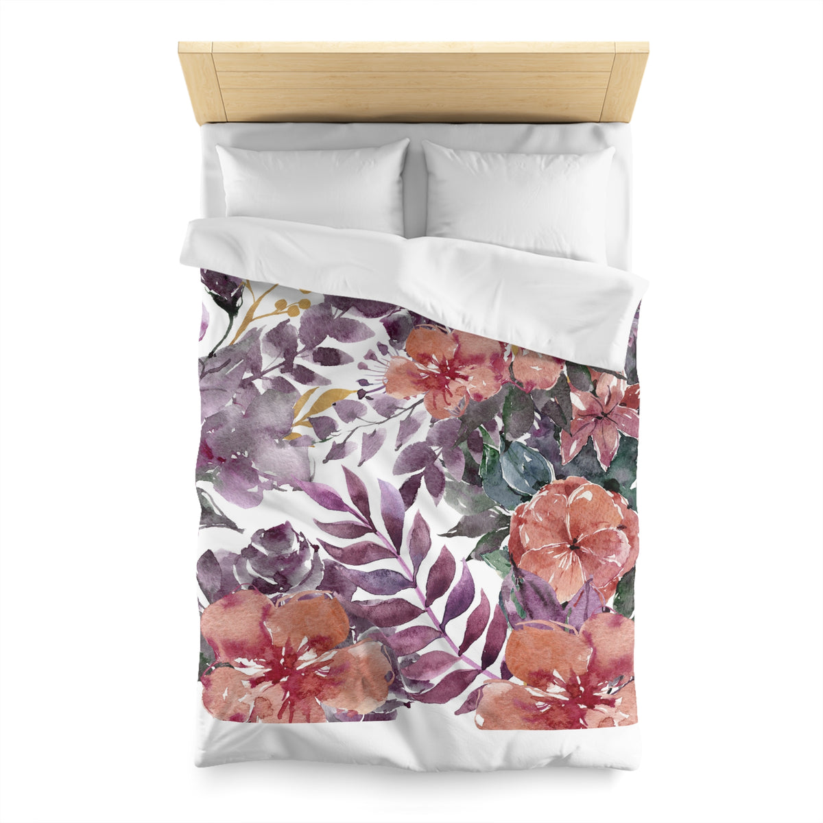 a bed with a floral patterned duvet cover and pillows.