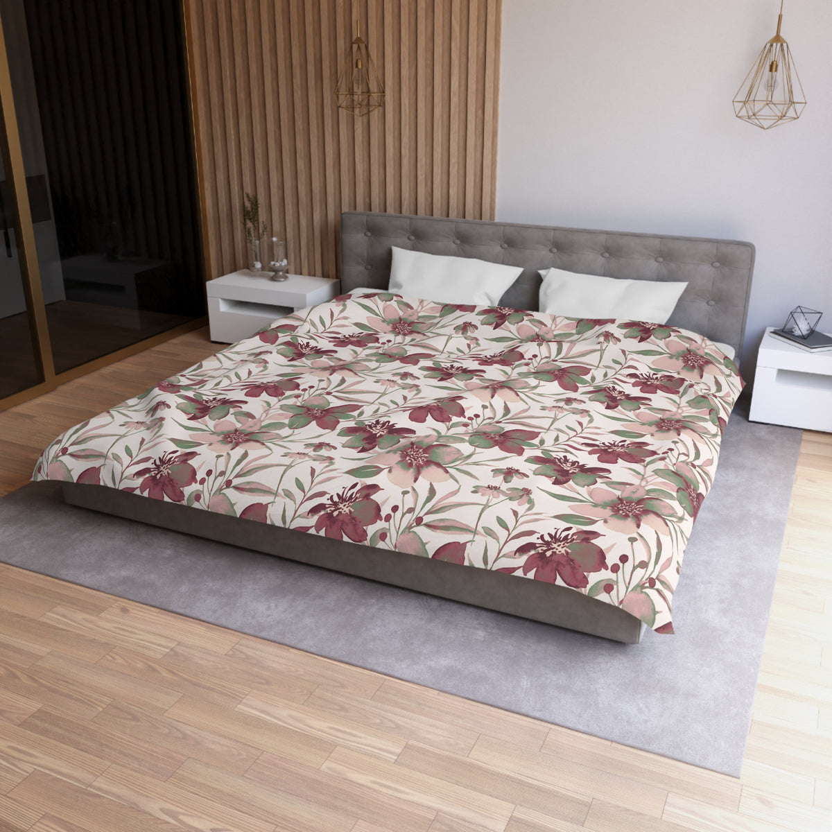 a modern bedroom with a large bed featuring a floral print comforter and pillows. The bed is positioned against a wall with a wooden panel design. The room has a wooden floor and a gray area rug. There are two nightstands on either side of the bed, and a pendant light hangs above the bed.