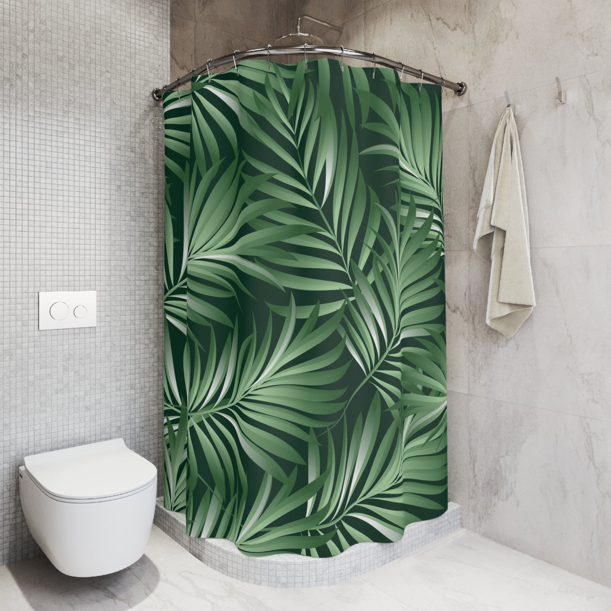 a bathroom with a shower curtain adorned with a tropical leaf pattern in shades of green. The shower curtain is hanging from a rod, and there is a towel hanging on the wall next to it. The bathroom has a white toilet and a tiled wall, creating a clean and modern aesthetic.