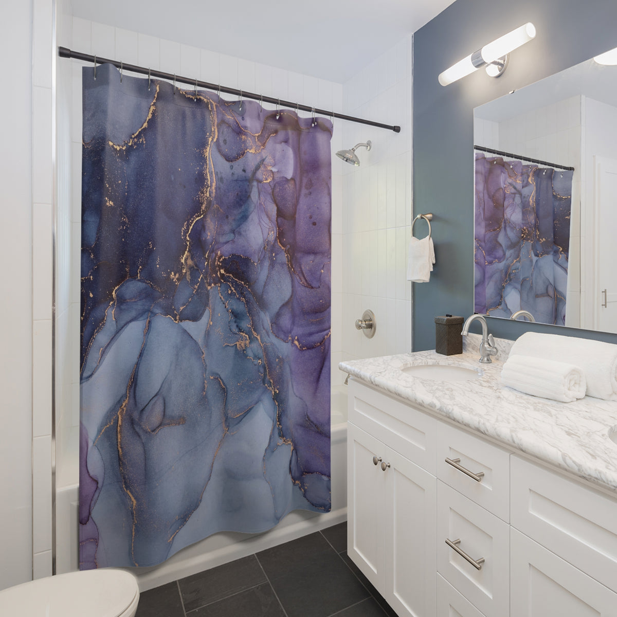 a modern bathroom with a white vanity, marble countertop, and a shower curtain with a purple and blue abstract design.