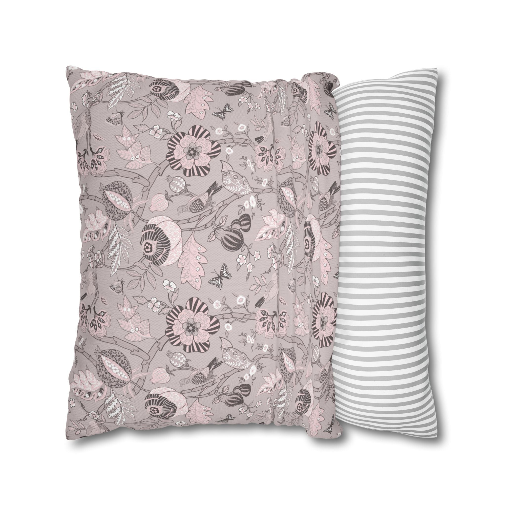a decorative pillow with a floral pattern in shades of pink and gray.