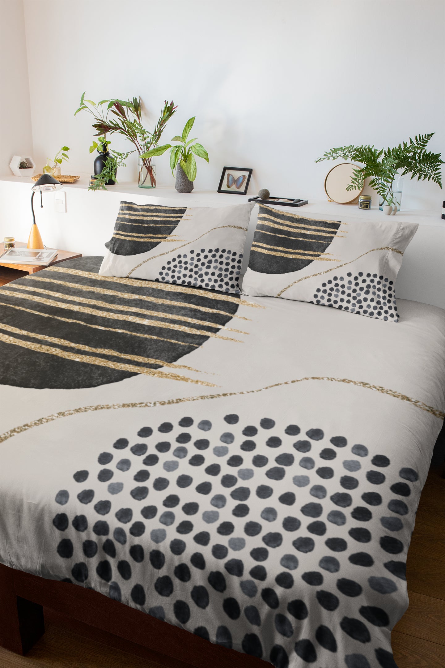 a bed with black and white sheets and pillows