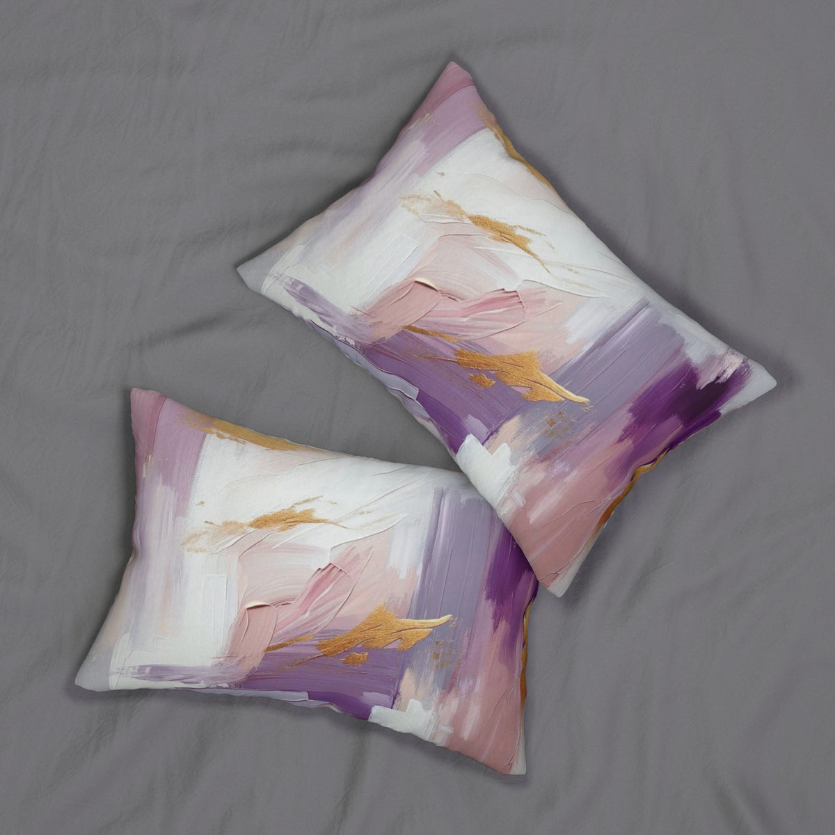 two decorative pillows with a vibrant abstract painting design, resting on a grey fabric surface.