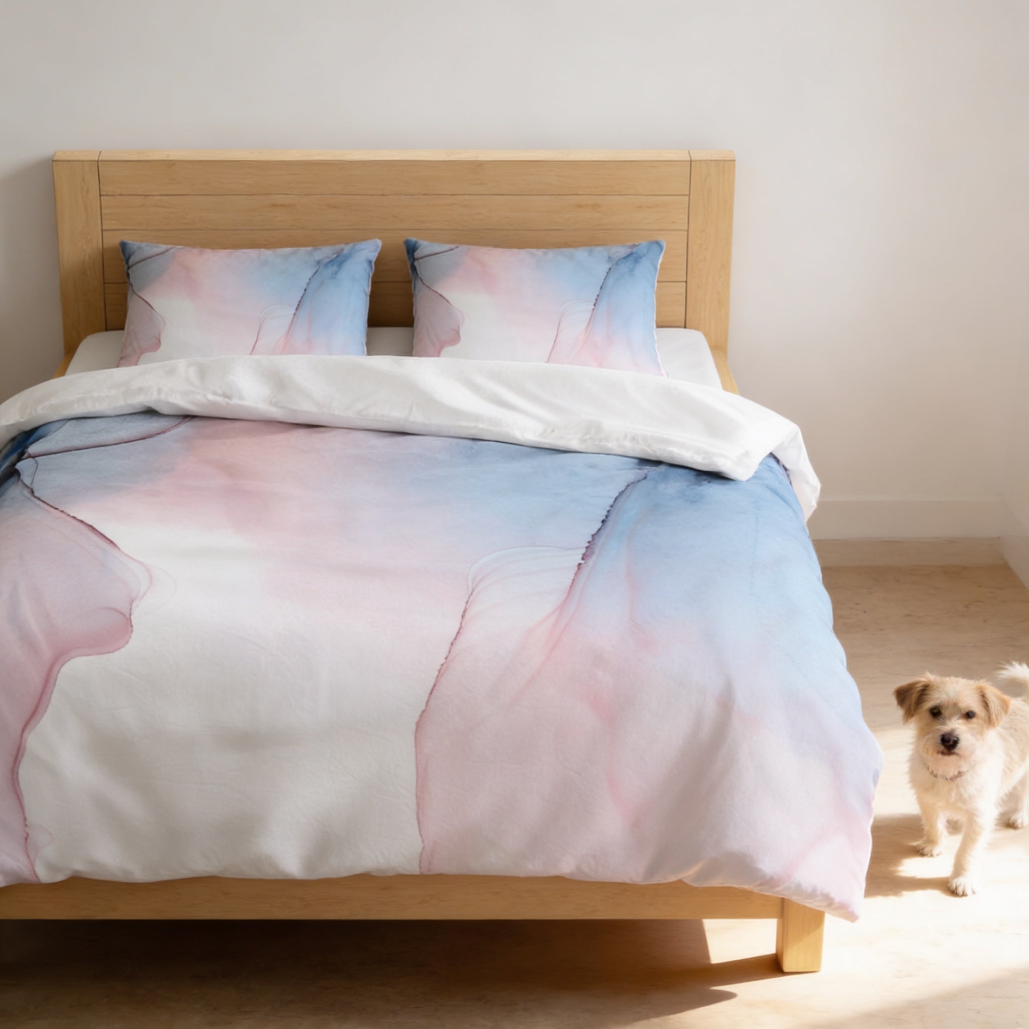 A cozy bedroom scene with a wooden bed frame, a white comforter with a pastel color gradient, and a small dog standing on the floor next to the bed.