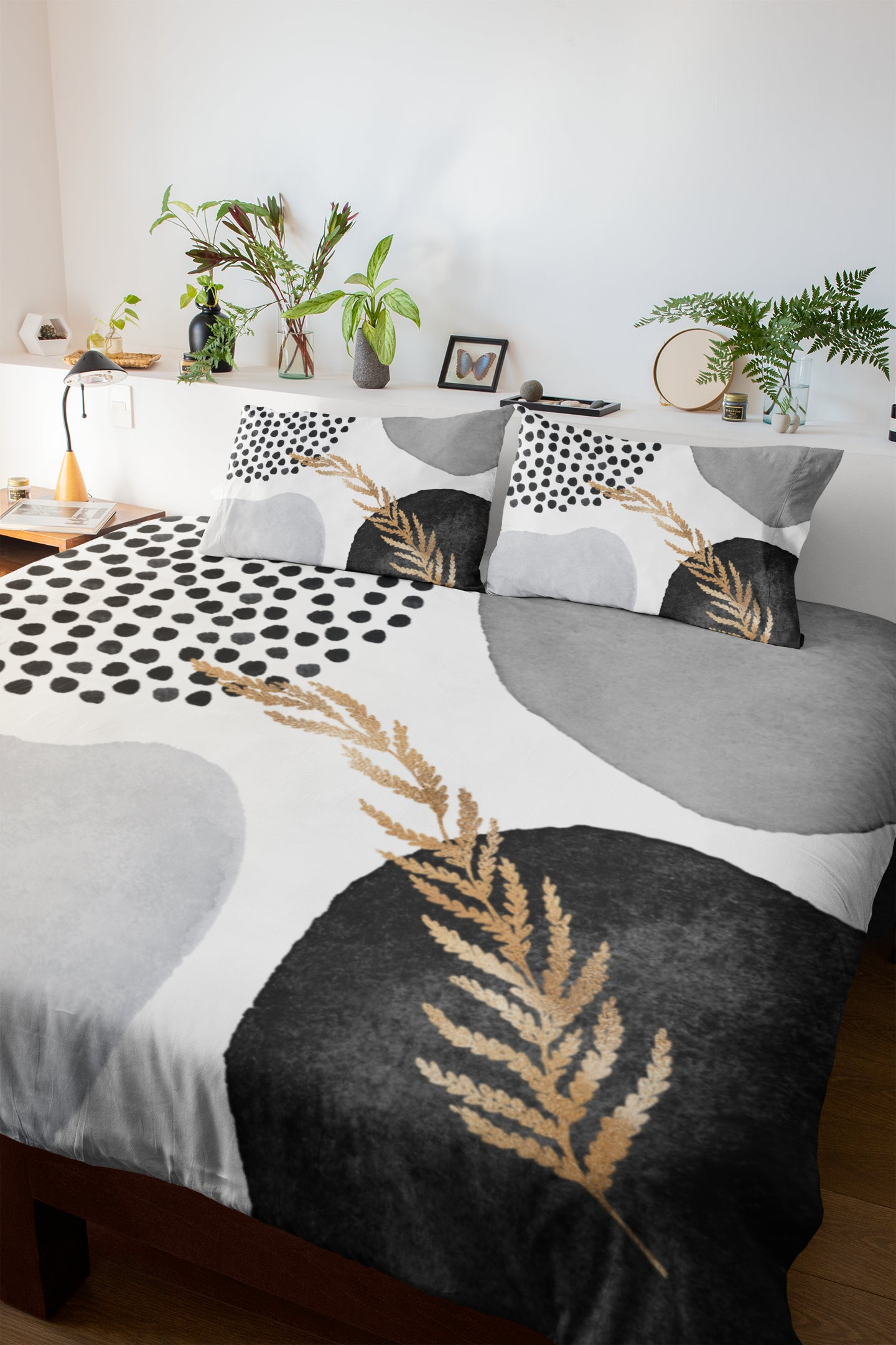 a bed with a black and white comforter and pillows