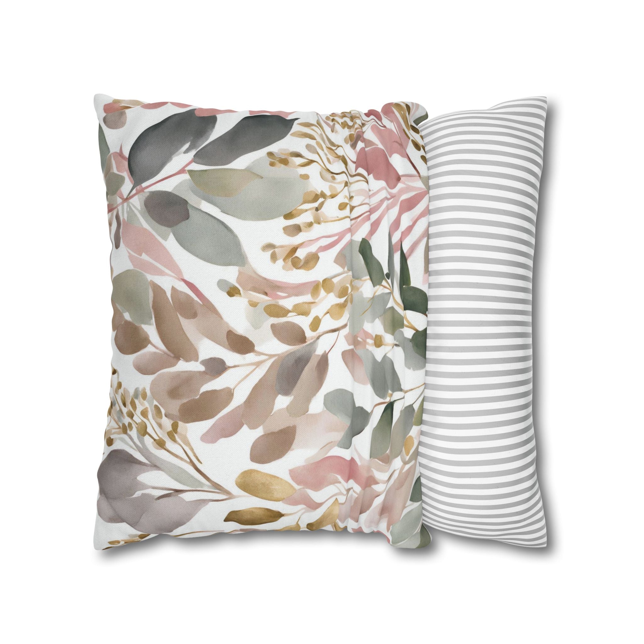 a decorative pillow with a floral pattern, including leaves and flowers in various shades of pink, green, and brown.