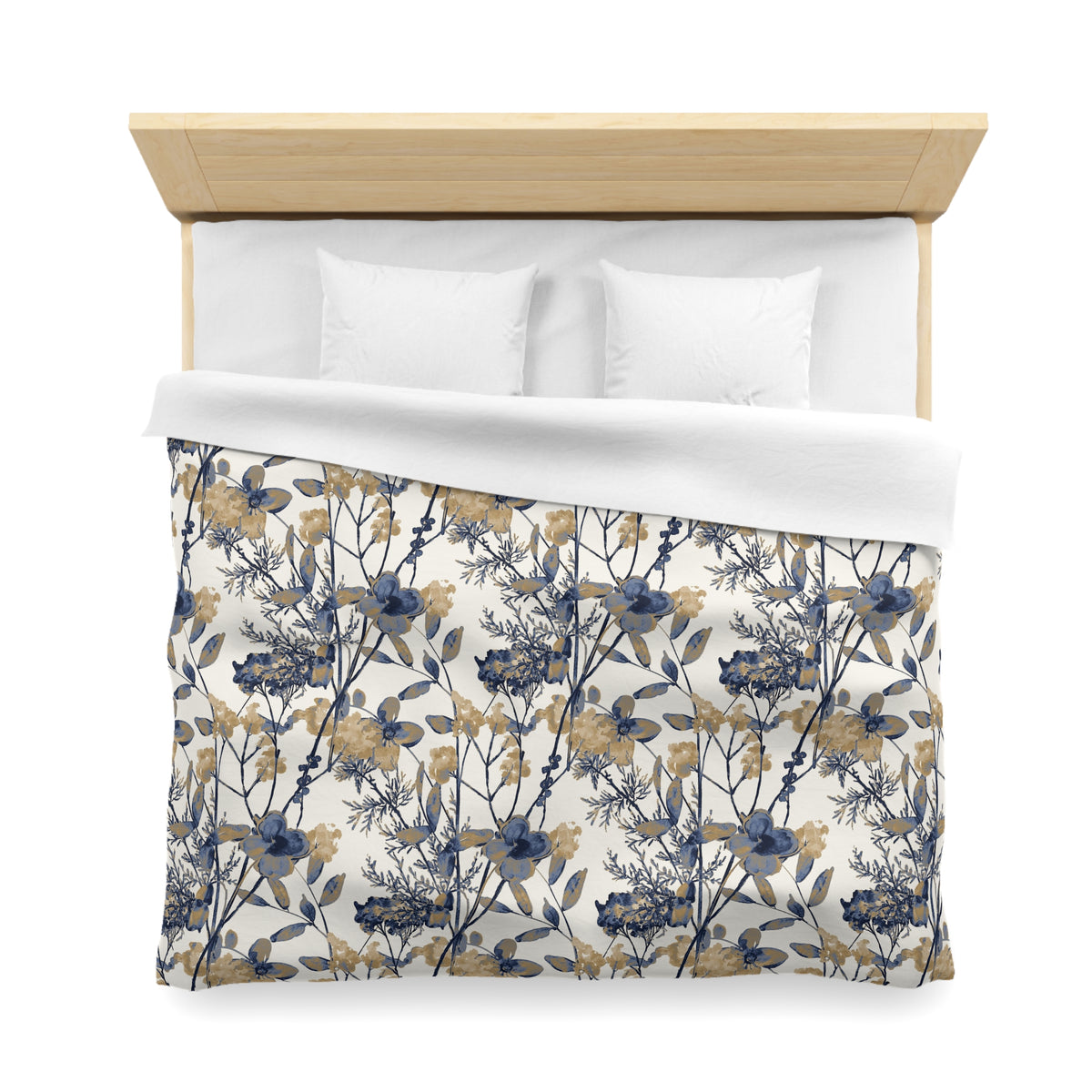 a neatly made bed with a floral print comforter and two white pillows.