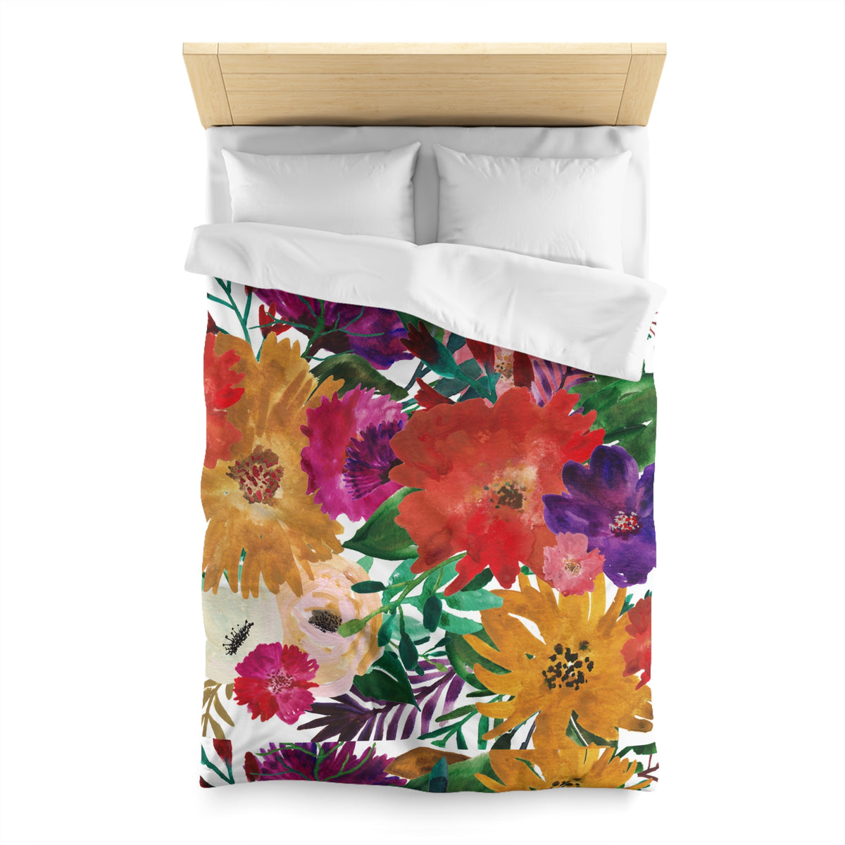 a bed with a colorful floral print duvet cover and pillows.