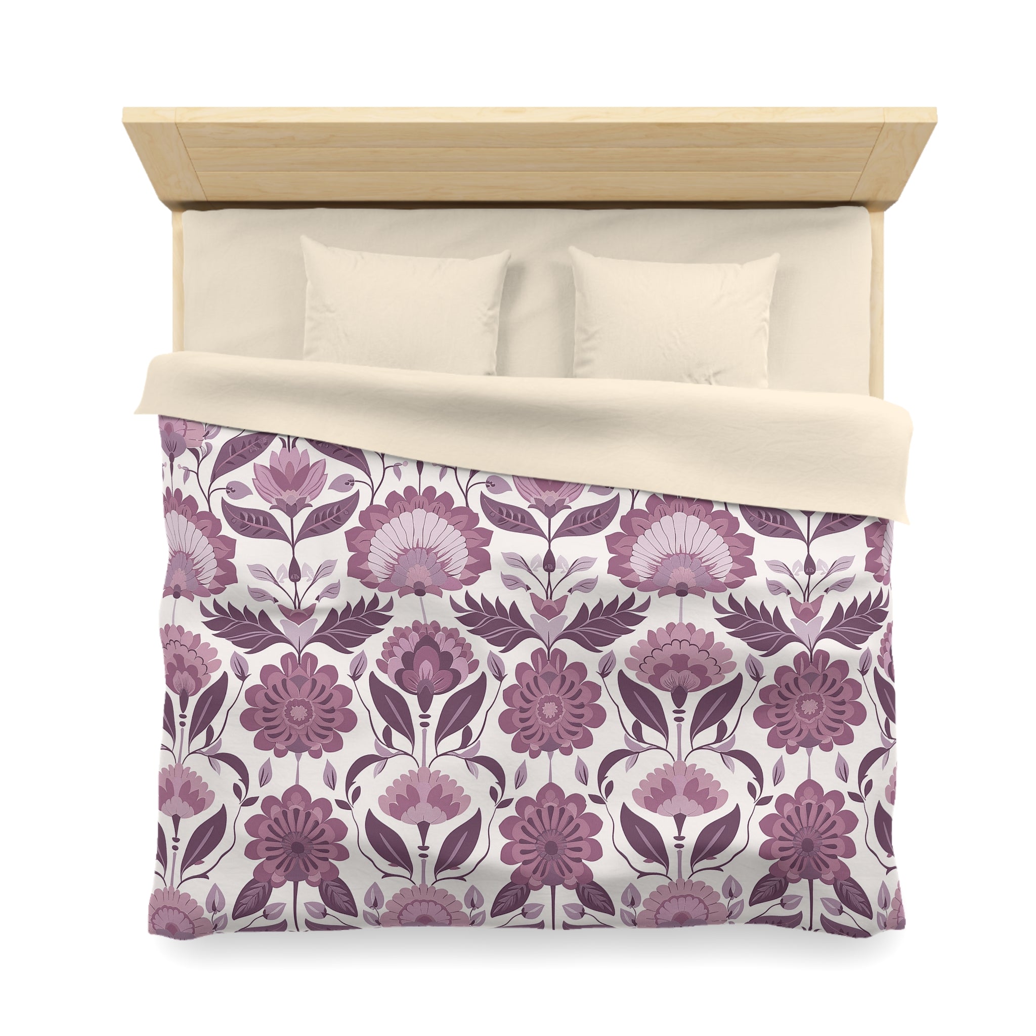 a neatly made bed with a floral patterned comforter and pillows.