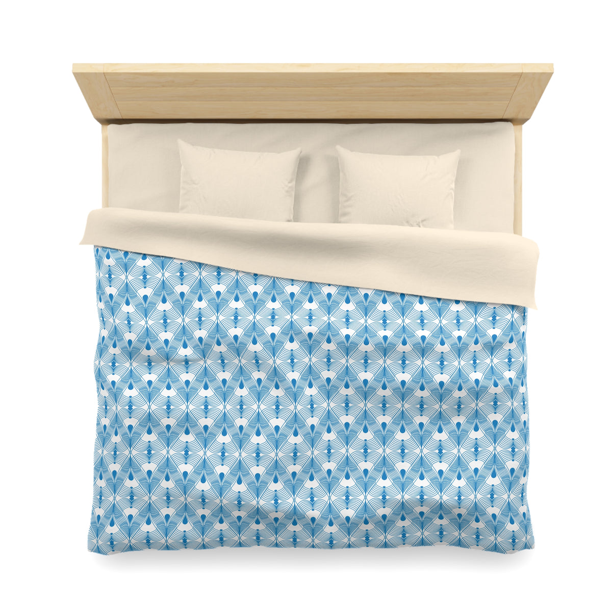 A neatly made bed with a blue and white patterned comforter and two pillows.
