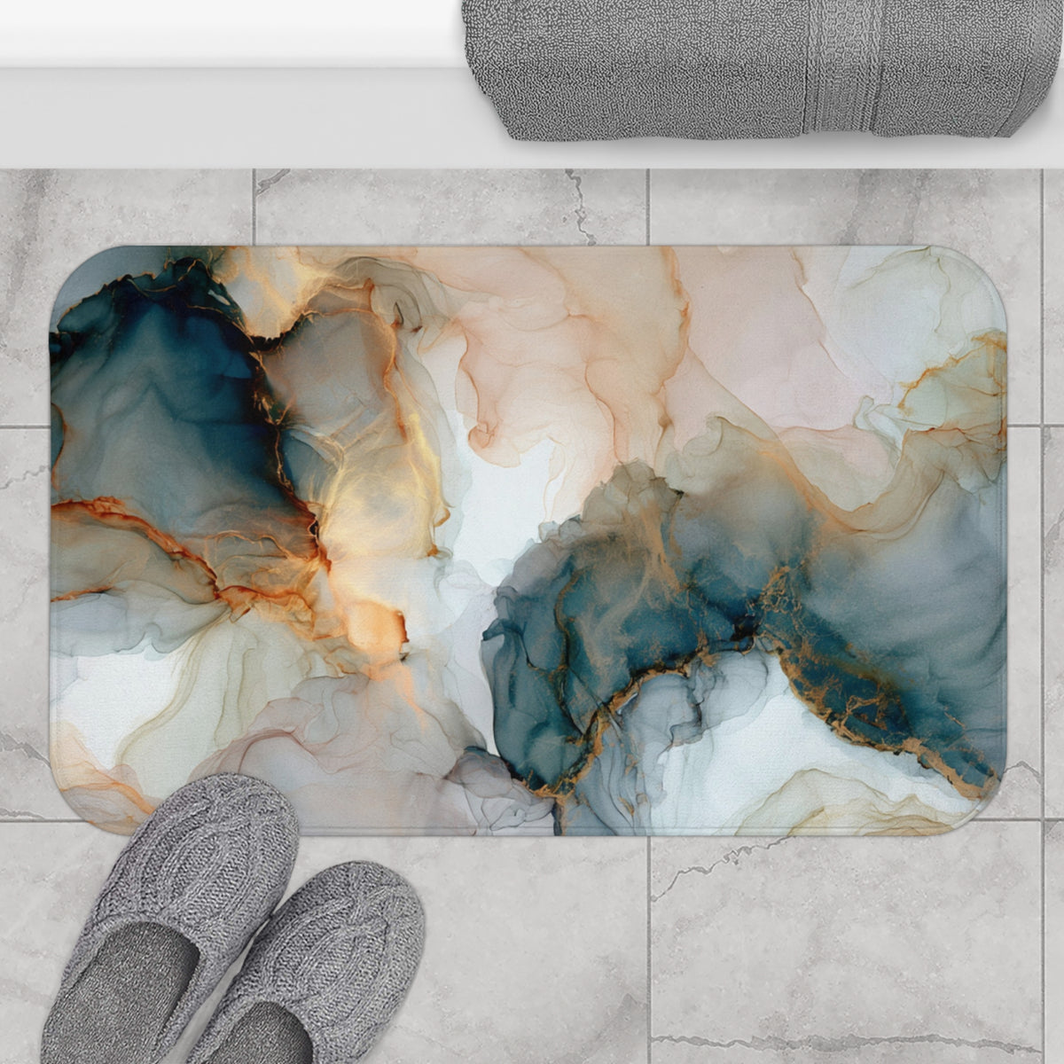 a bathroom floor with a marble-like pattern, including shades of blue, orange, and white. There are gray slippers placed on the floor, and a towel is visible in the top right corner.