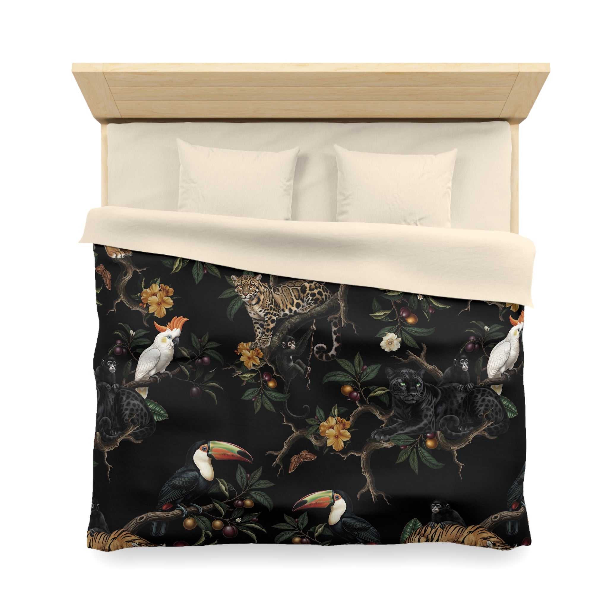 a bed with a black and white patterned comforter that includes various tropical animals such as a parrot, a jaguar, and a toucan.
