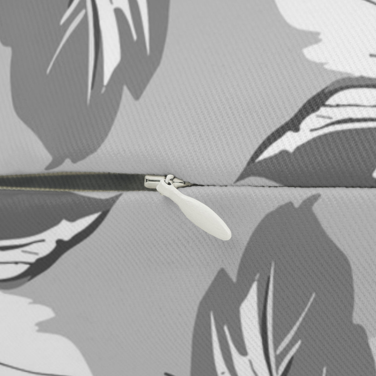 A close-up view of a zipper on a fabric, with a white zipper pull visible.