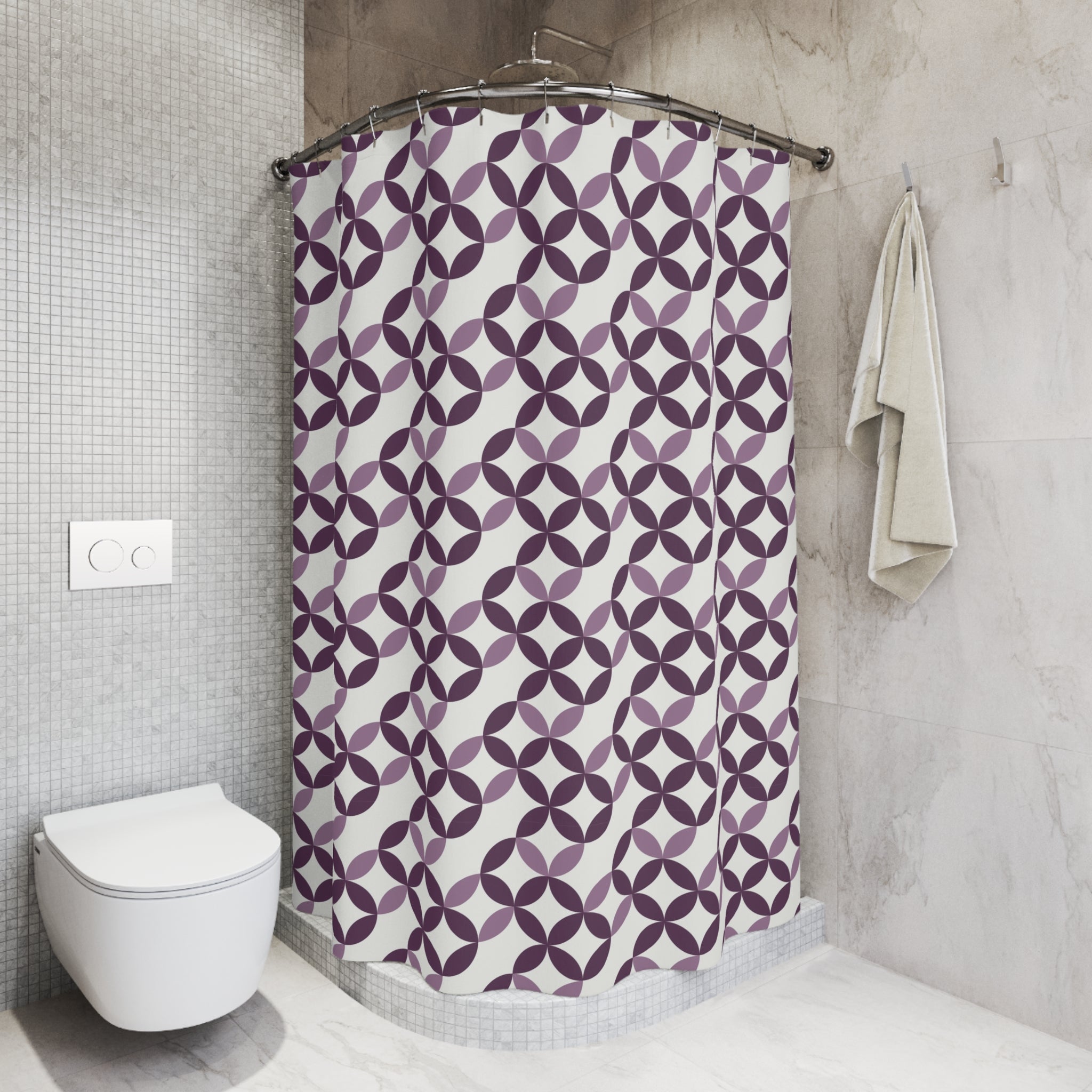 a bathroom with a shower curtain featuring a purple and white geometric pattern. The shower is located next to a toilet, and there is a towel hanging on the wall.
