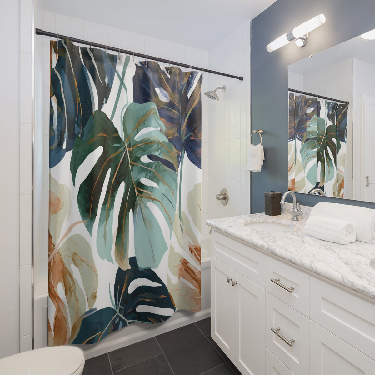 a modern bathroom with a white vanity, a shower curtain featuring a tropical plant design, and a mirror above the vanity.