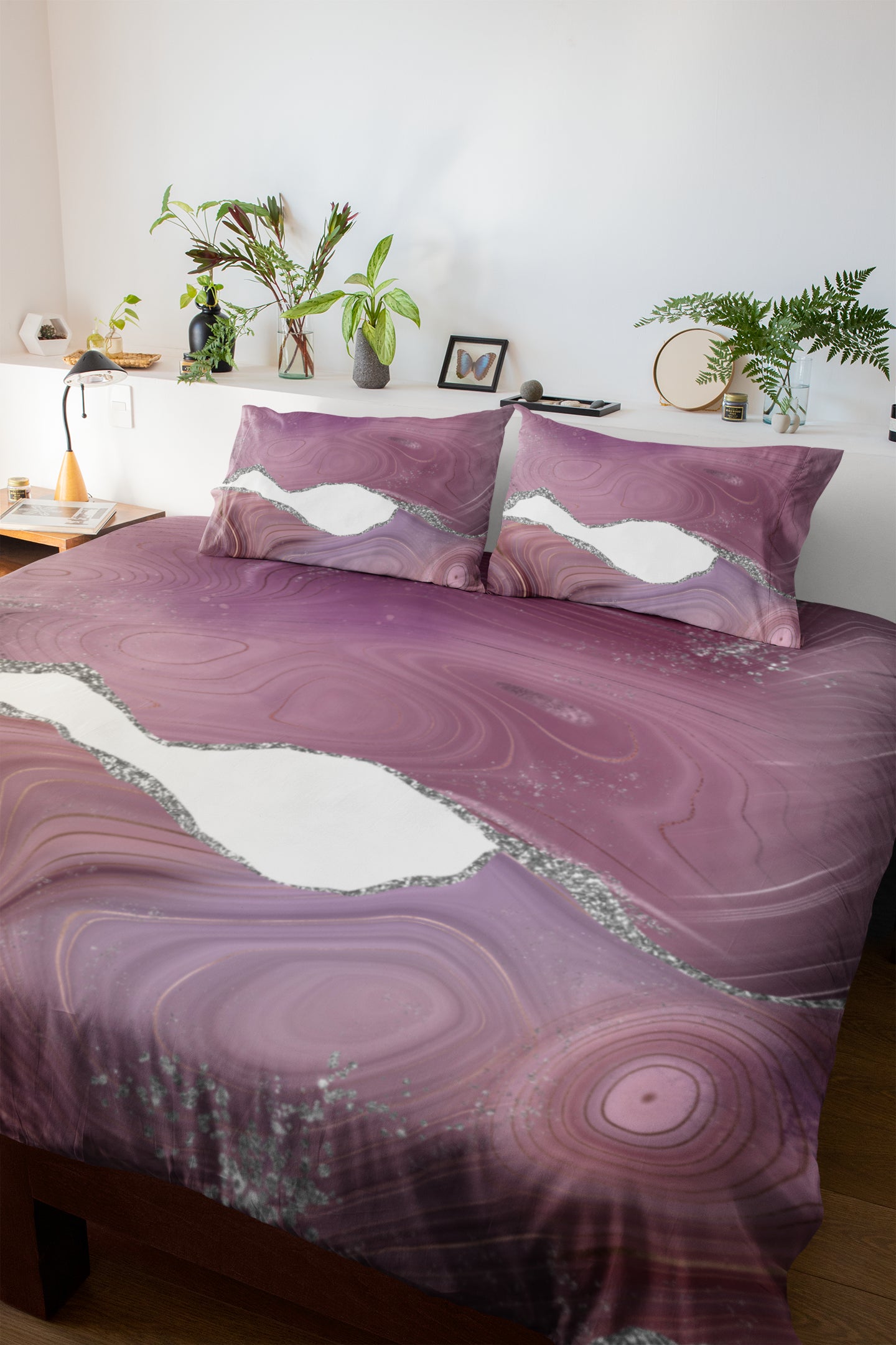 a bed with a purple comforter and matching pillows