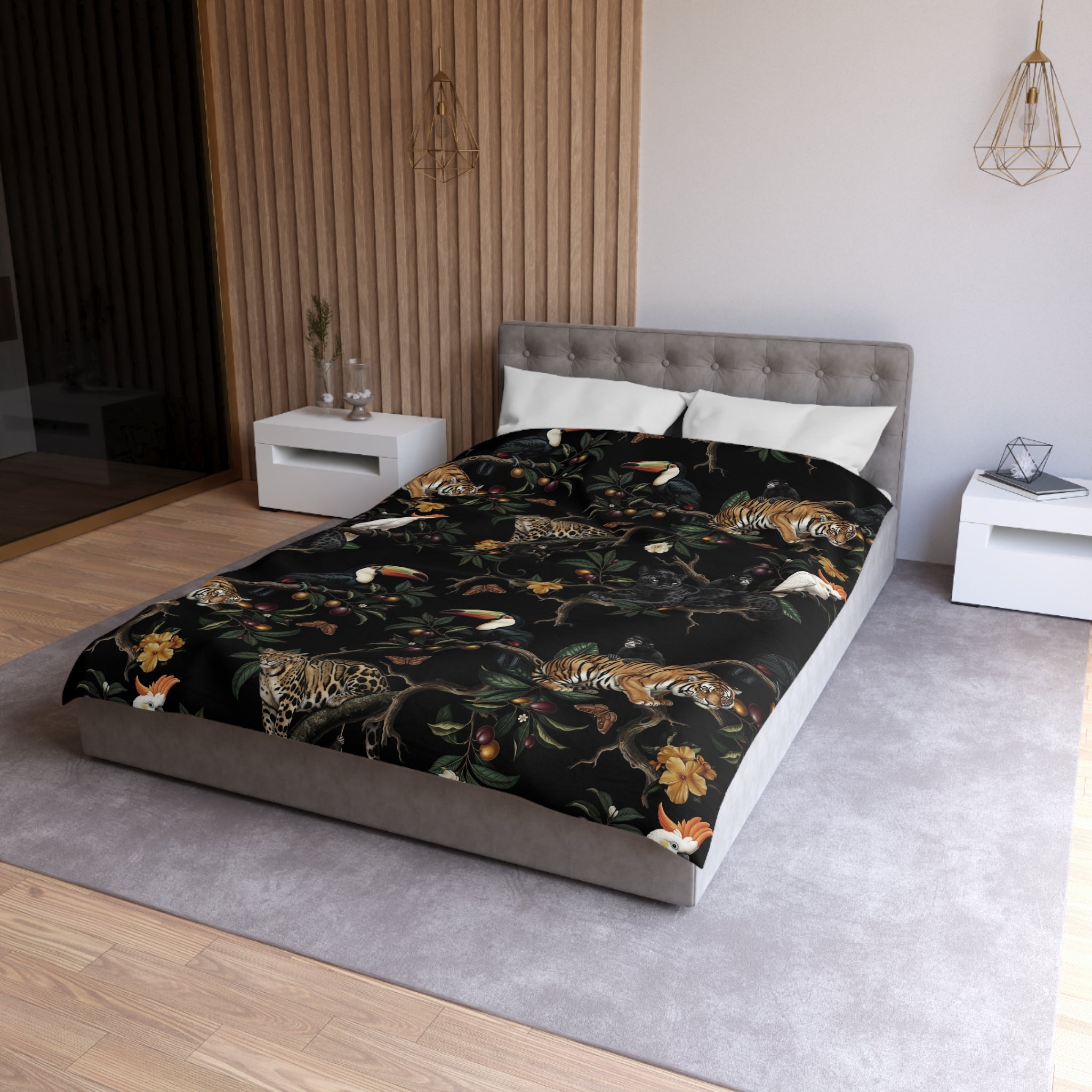 a modern bedroom with a large bed covered in a black and orange tiger print comforter. The bed is positioned against a wall with a wooden panel design. The room also includes white nightstands and a gray headboard.