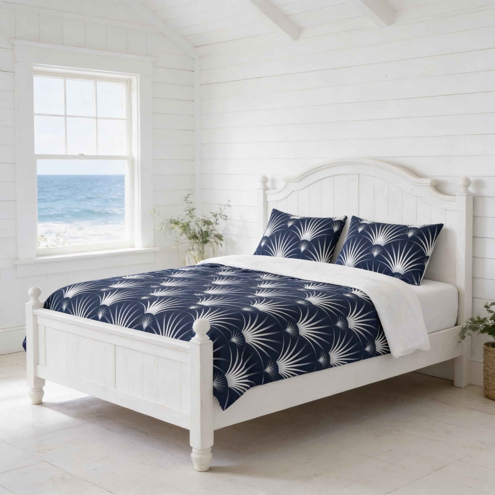 a serene bedroom with a white wooden bed frame, a blue and white patterned comforter, and a window overlooking the ocean.