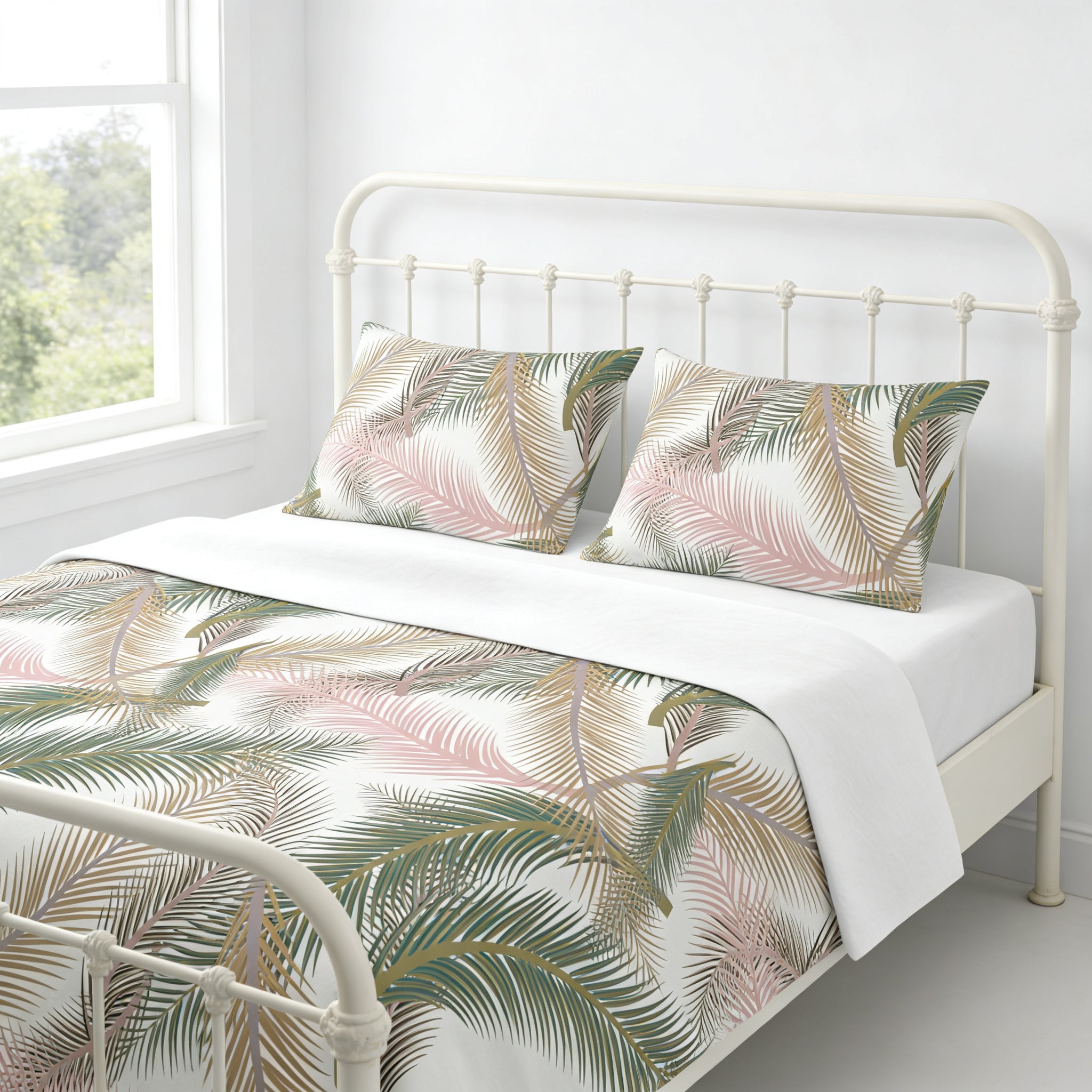 a white metal bed frame with a white headboard and a white comforter with a tropical leaf pattern.