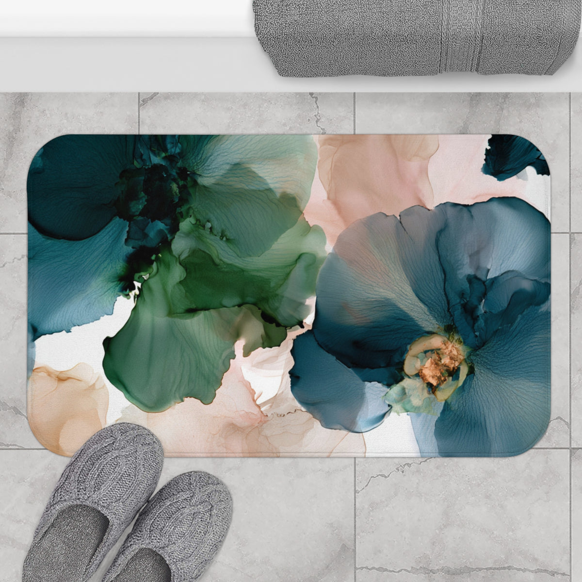 a pair of gray slippers sitting on top of a rug