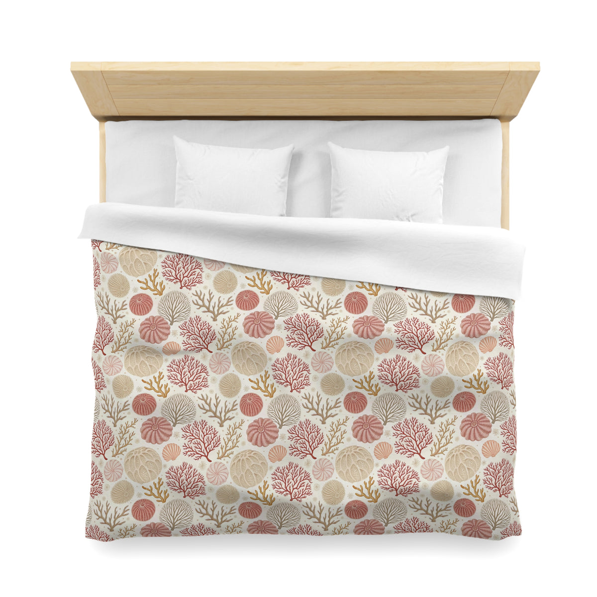 a neatly made bed with a patterned comforter featuring a design of various marine life, including coral, shells, and other sea creatures.