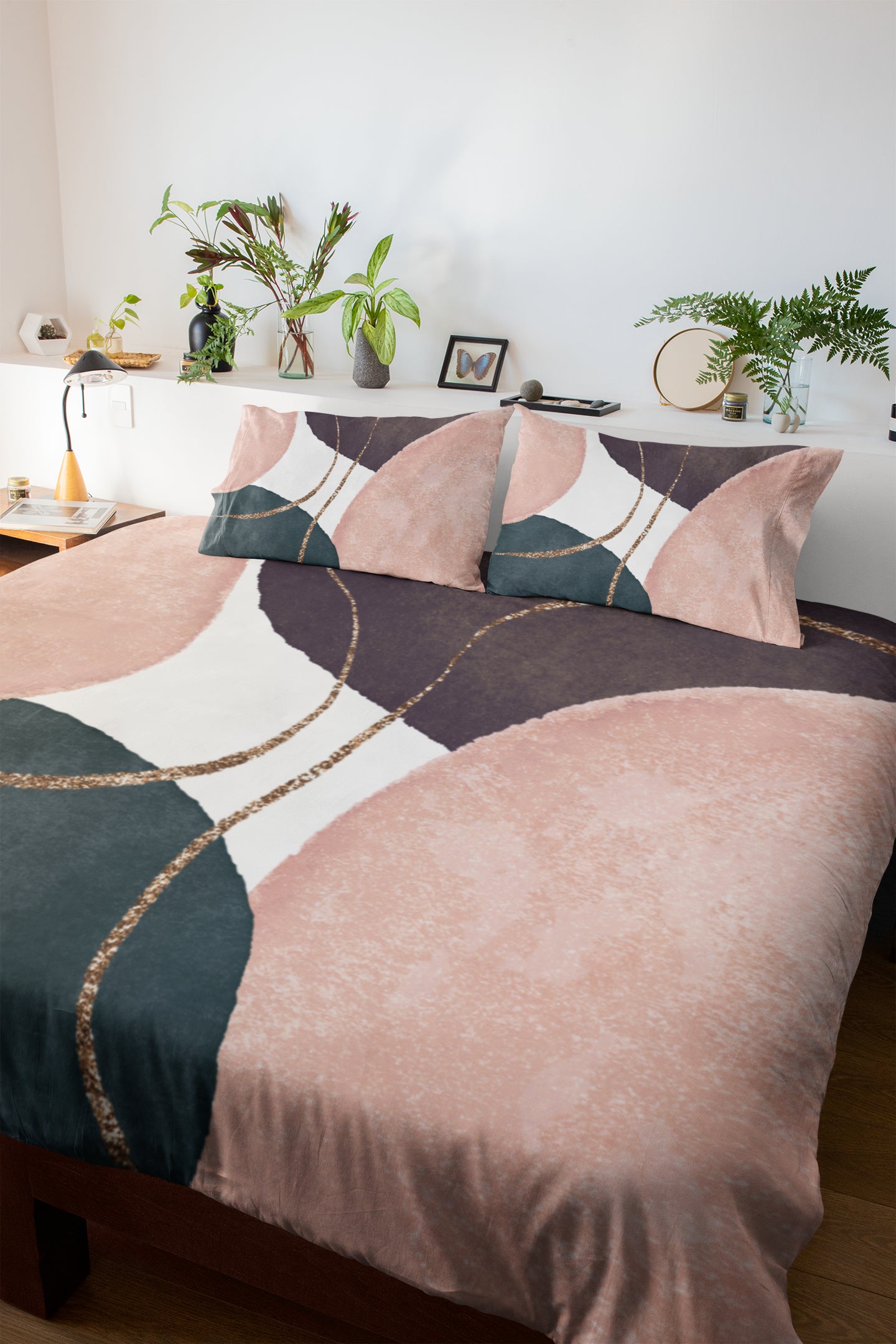 a bed with a pink and green comforter and pillows