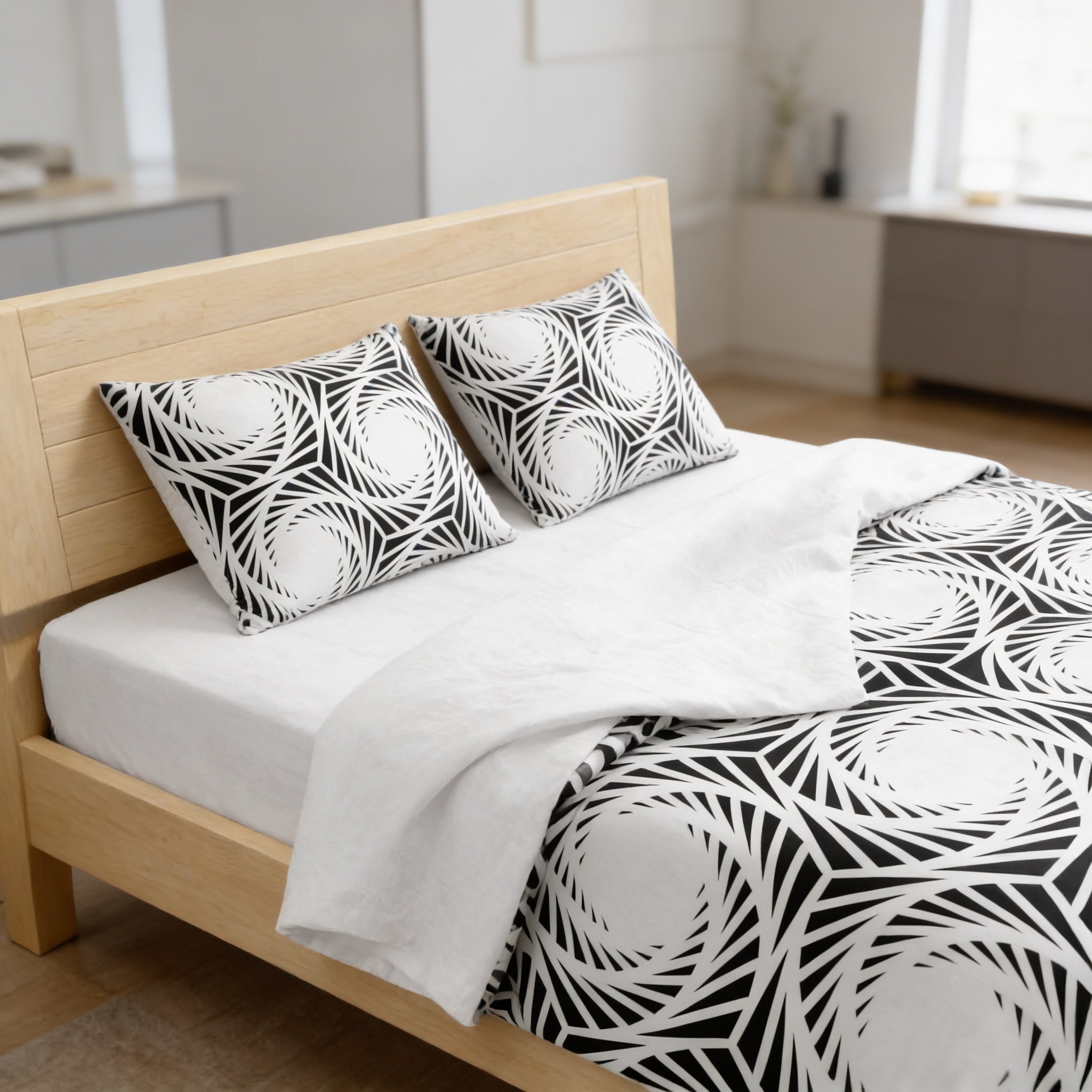 a modern bedroom with a wooden bed frame and a black and white patterned comforter.