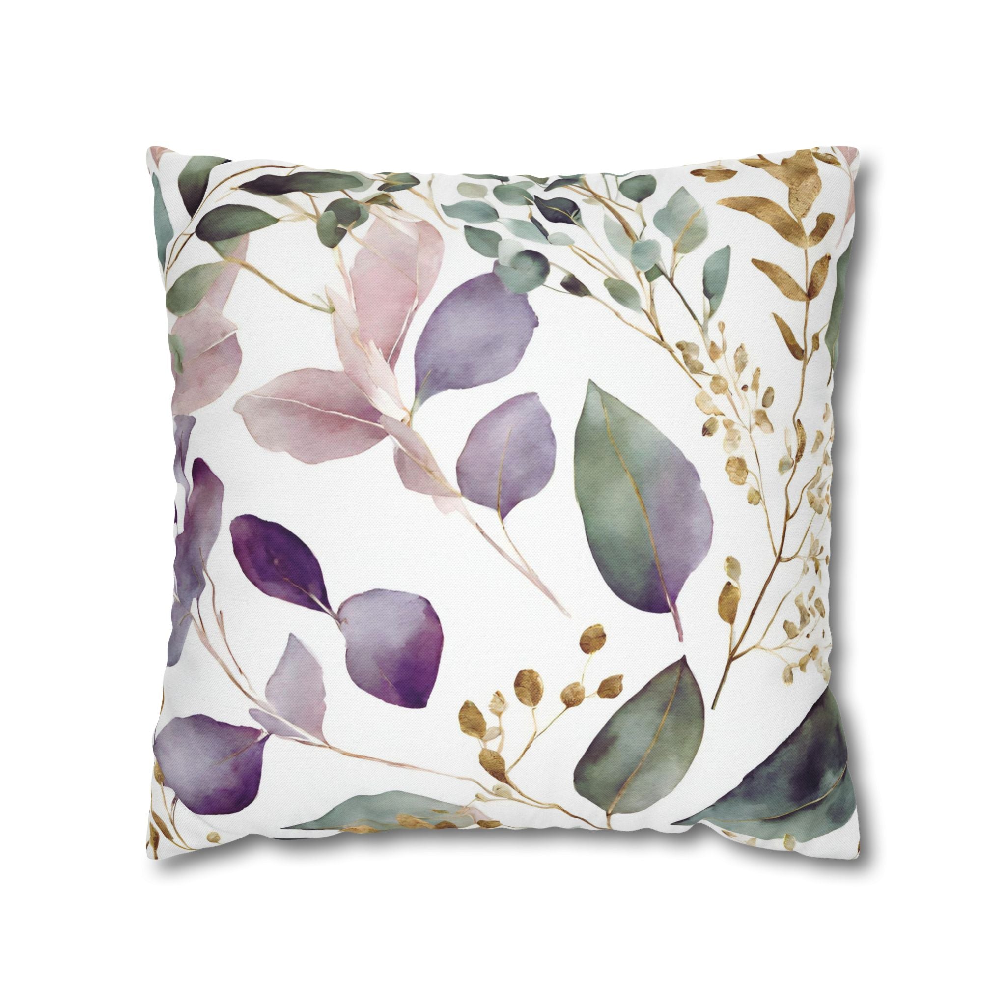 a square pillow with a floral print design. The design consists of various shades of green leaves and flowers, along with some gold accents. The colors used are predominantly green, purple, and gold, creating a visually appealing and harmonious pattern.
