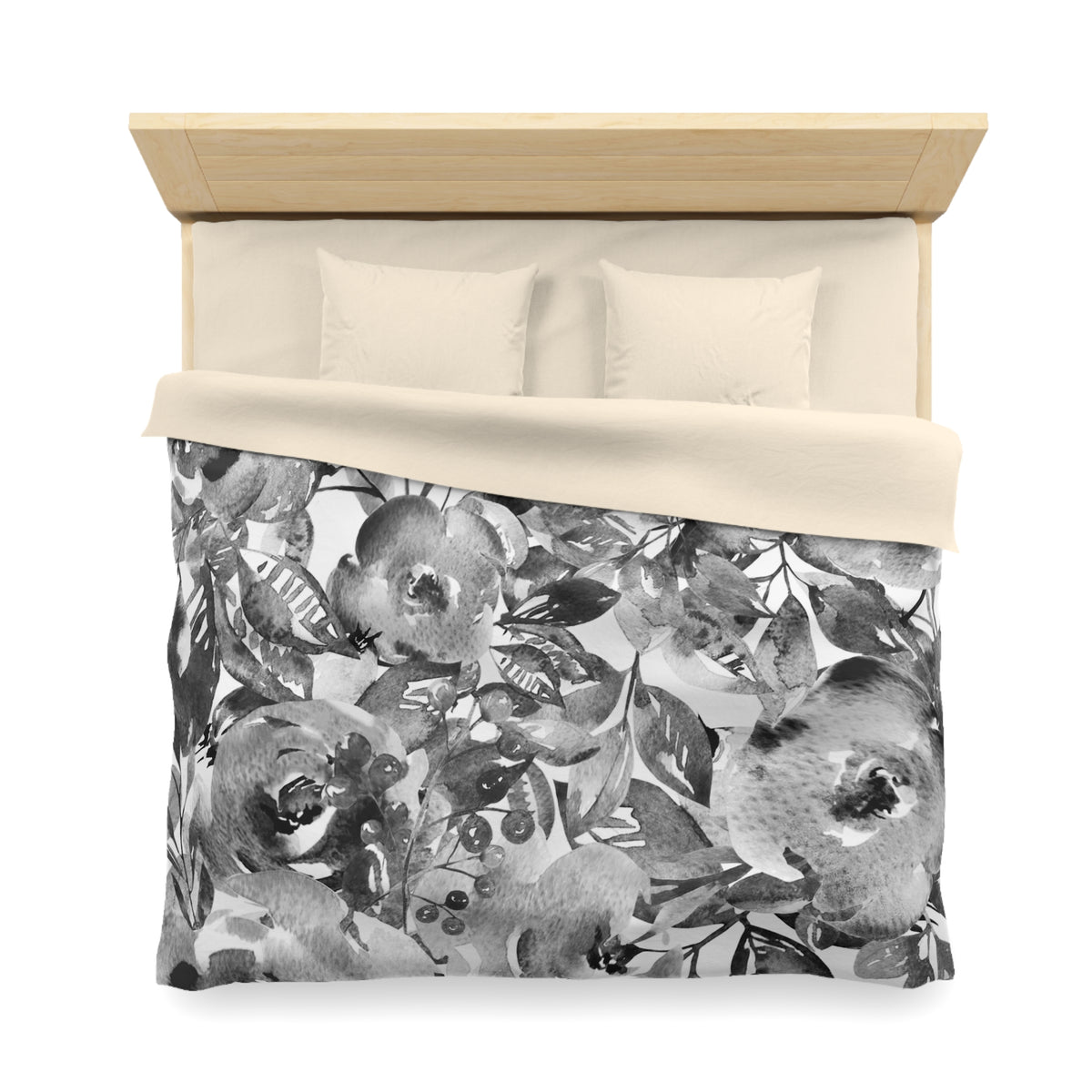 a bed with a floral print duvet cover and pillows.