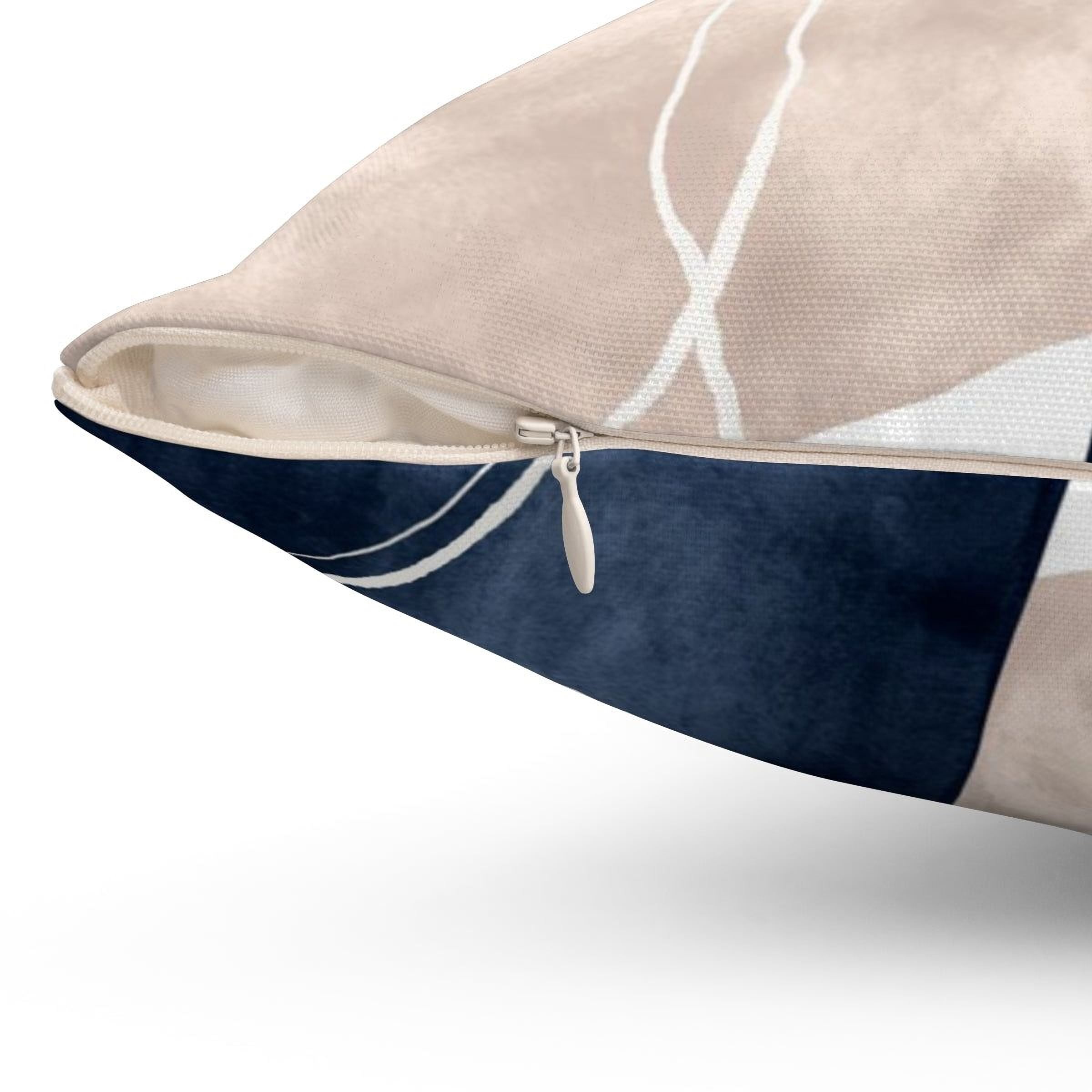 a close-up view of a pillow with a zipper and a blue and beige patterned fabric.