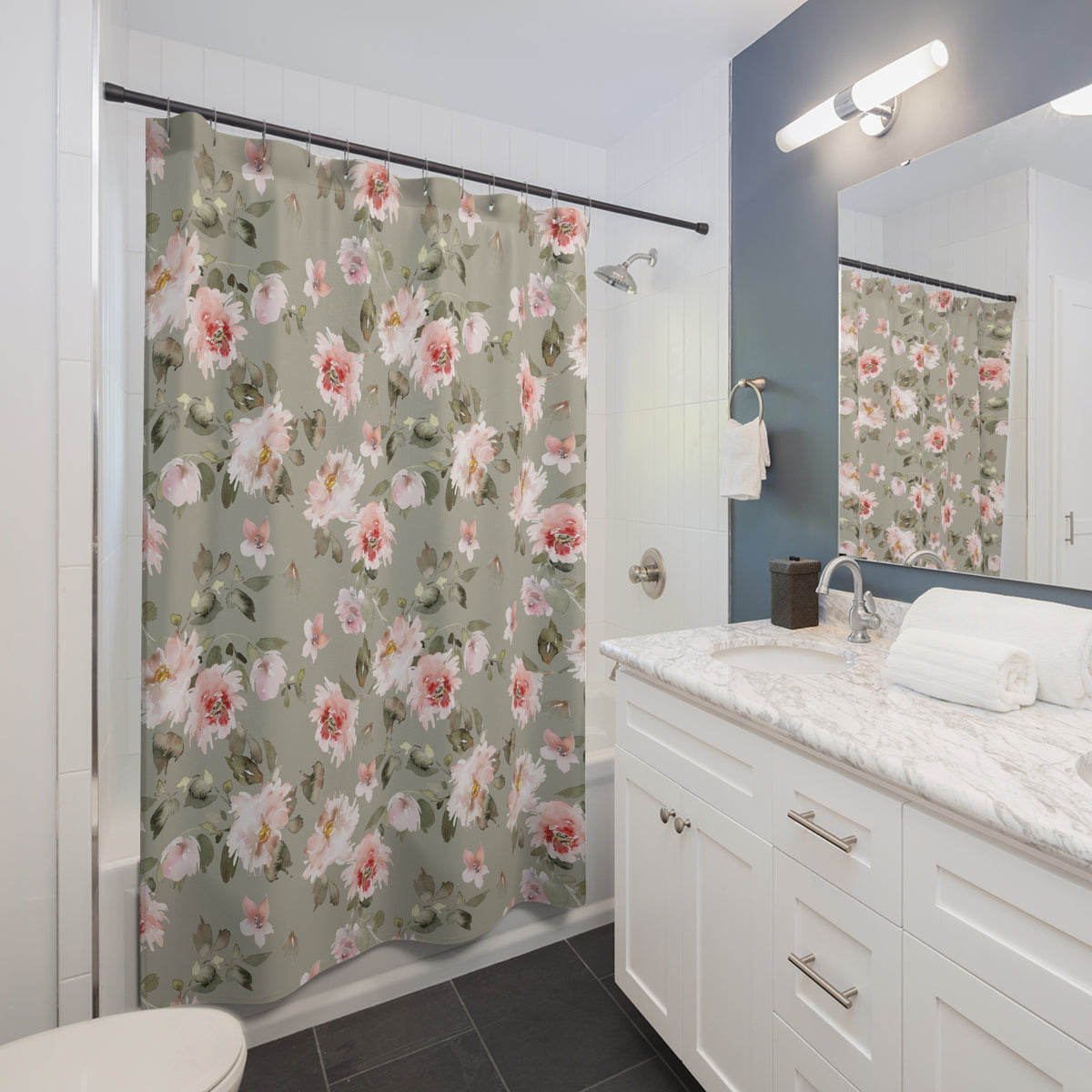 a bathroom with a floral patterned shower curtain, a white vanity with a marble countertop, and a mirror above the vanity.
