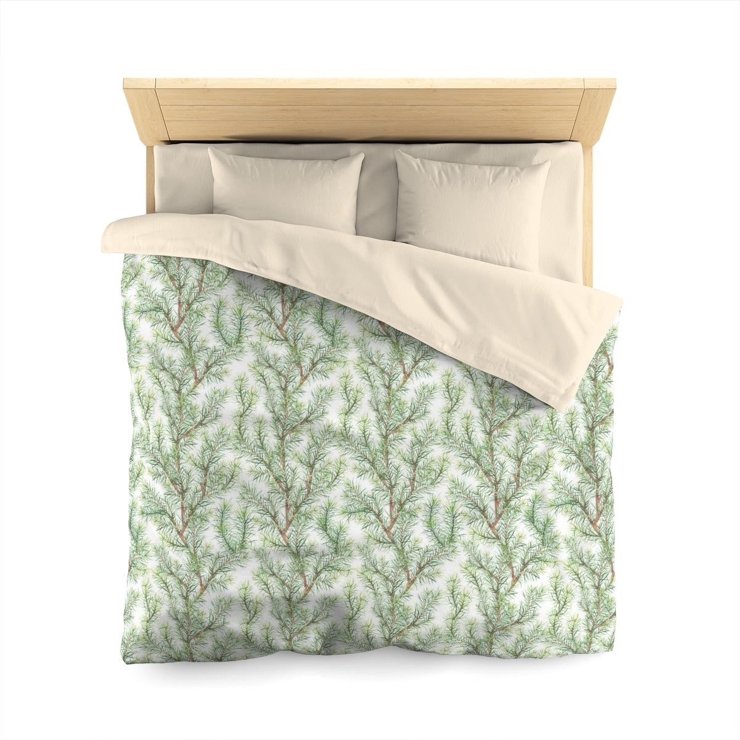 a neatly made bed with a green and white patterned comforter and pillows.