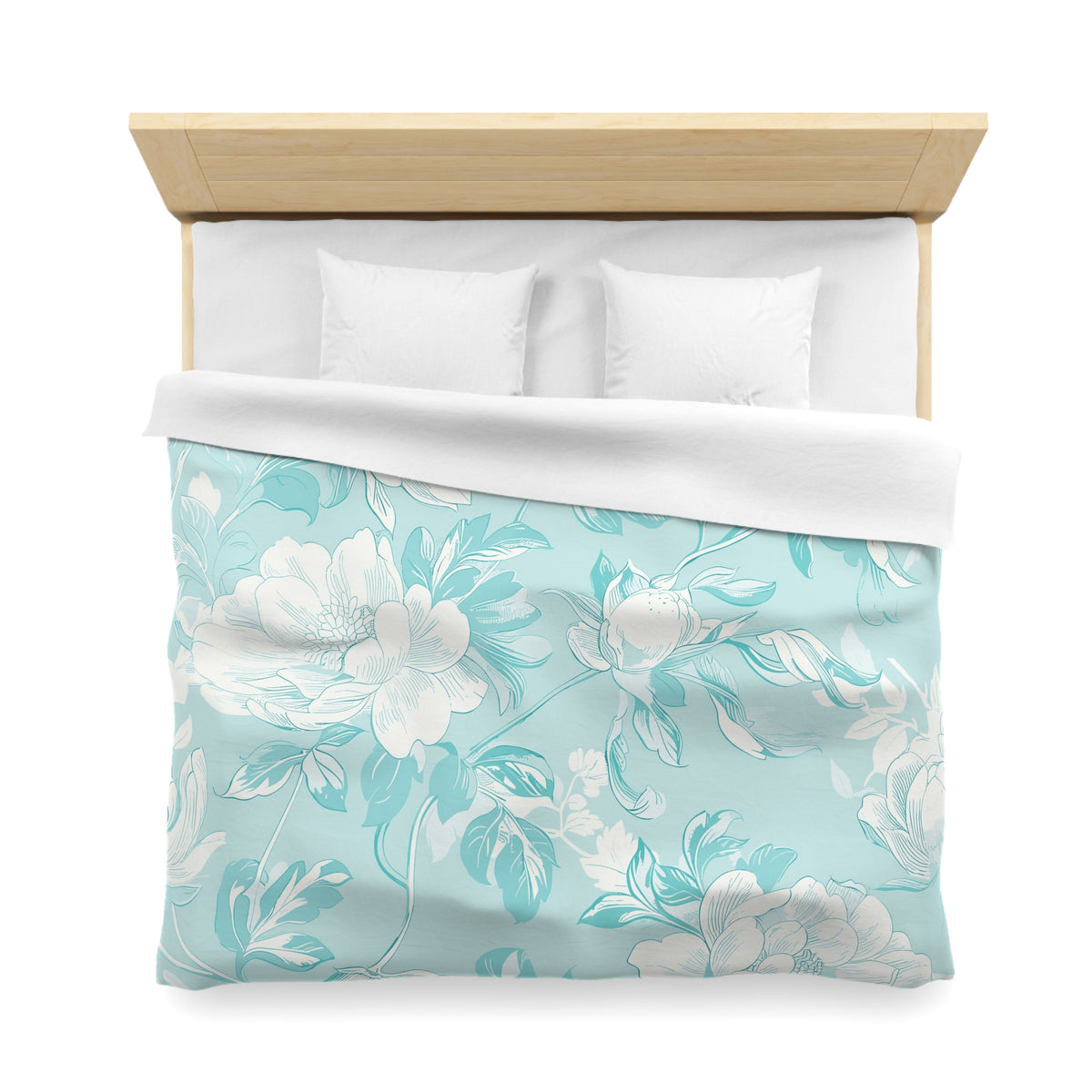 a neatly made bed with a floral patterned comforter and pillows.