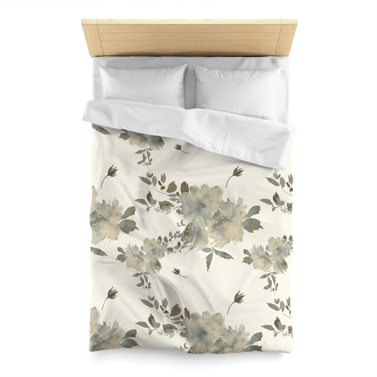 a neatly made bed with a floral patterned comforter and pillows.