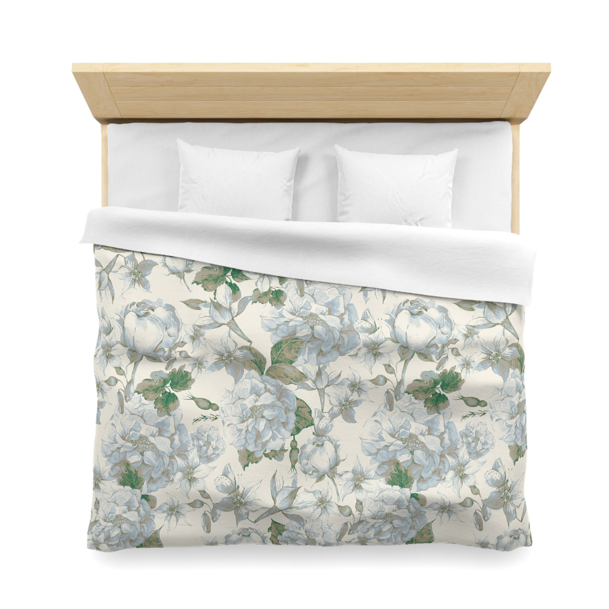 a neatly made bed with a floral patterned comforter and pillows.