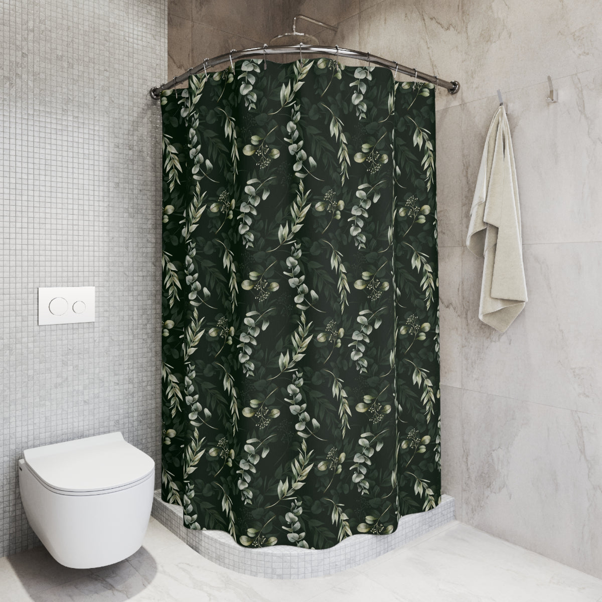 a bathroom with a shower curtain adorned with a green leaf pattern. The shower curtain is hanging from a rod next to a towel. The bathroom has a white toilet and a white tiled wall.