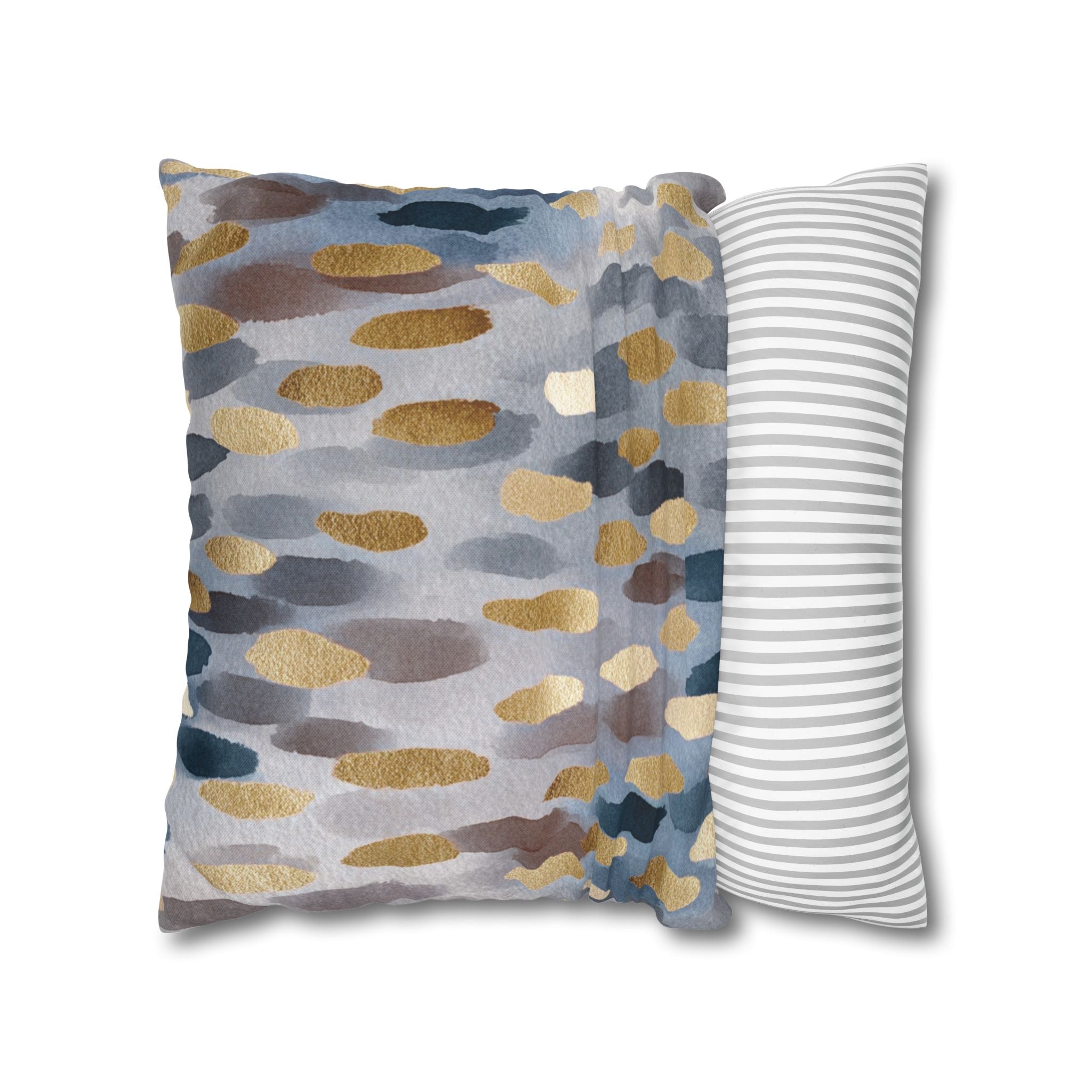 a decorative pillow with a unique abstract pattern of blue, gray, and gold colors.