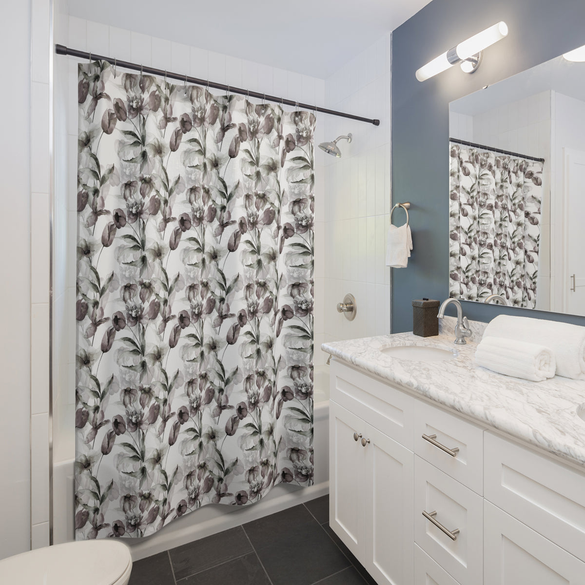 a modern bathroom with a white vanity, a shower curtain with a floral pattern, and a mirror above the vanity.