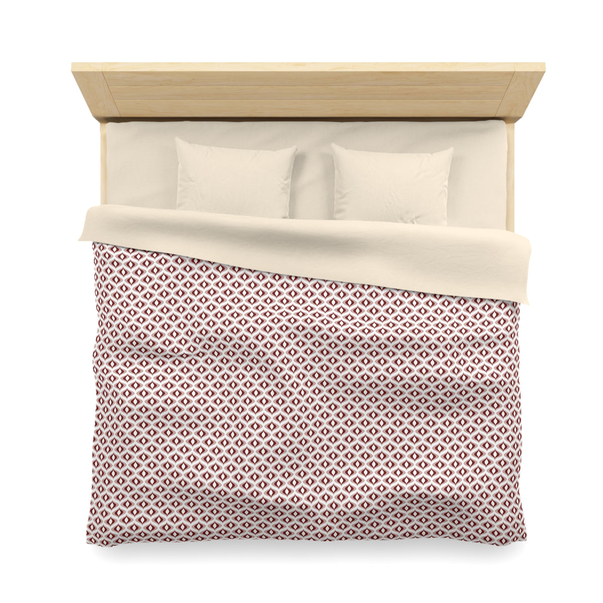 A neatly made bed with a red and white patterned comforter and two white pillows.