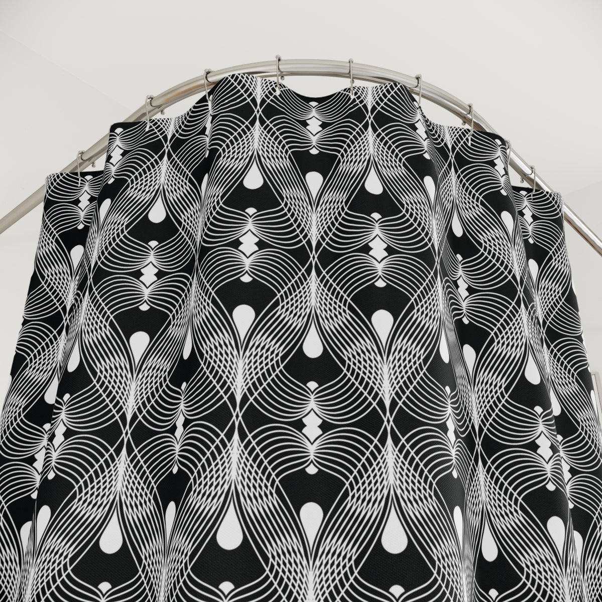 a black and white patterned shower curtain with a repeating geometric design.