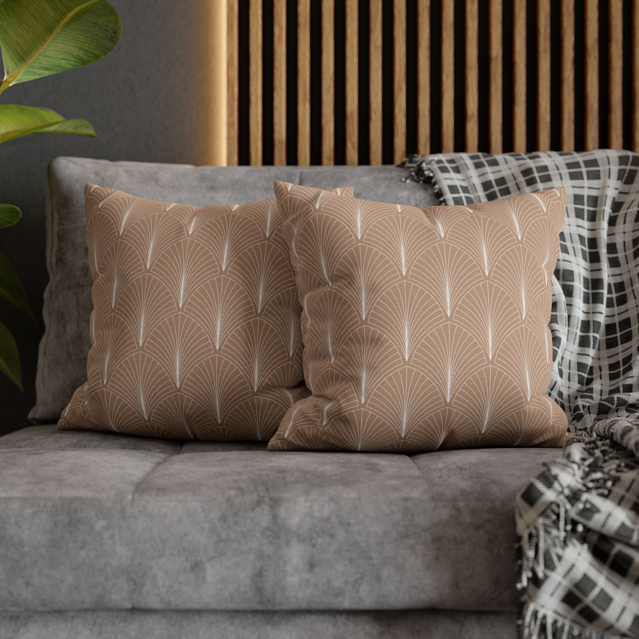 a gray sofa with two throw pillows featuring a repeating pattern of white lines and circles, creating a modern and stylish aesthetic.