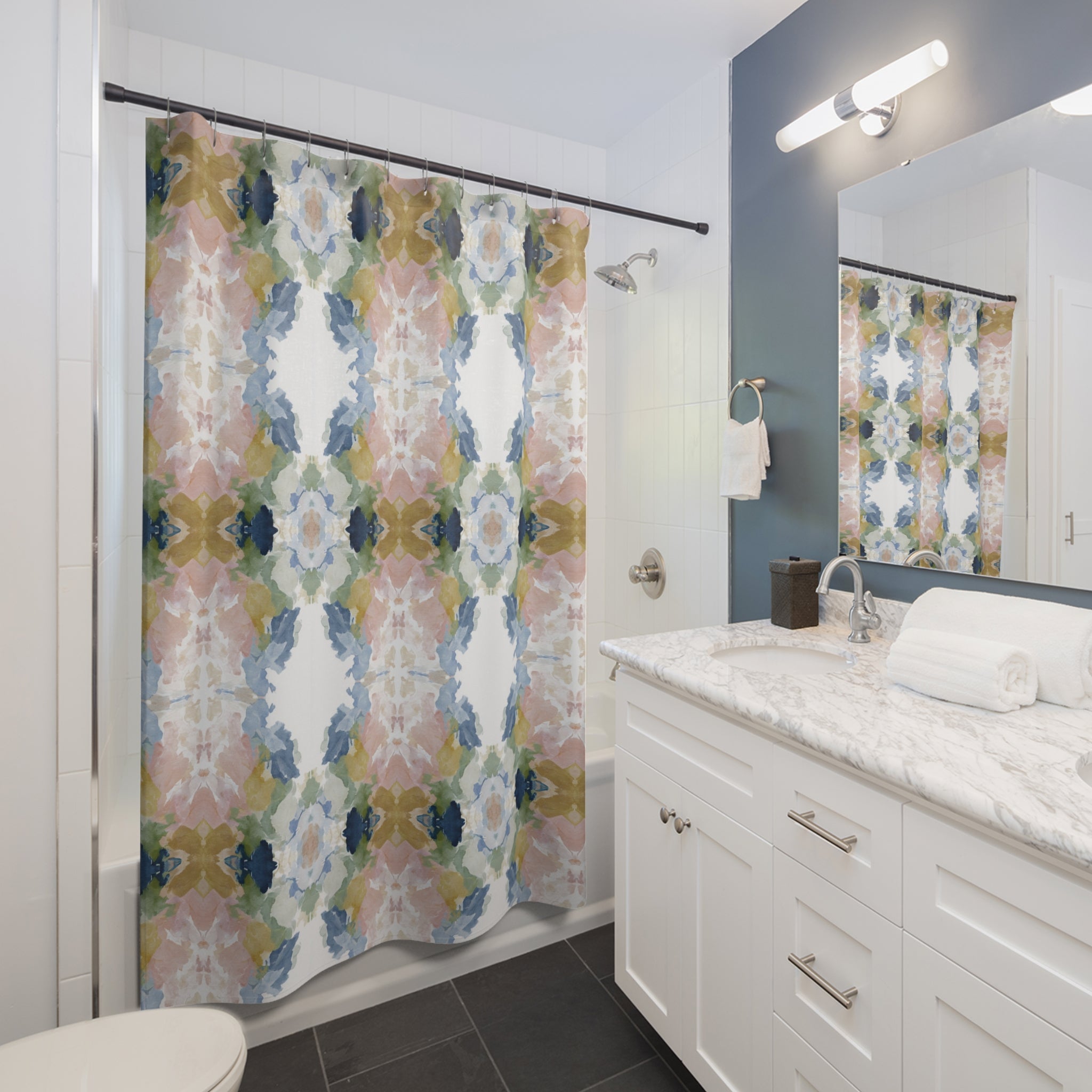 a modern bathroom with a white vanity, a colorful shower curtain, and a mirror above the sink.