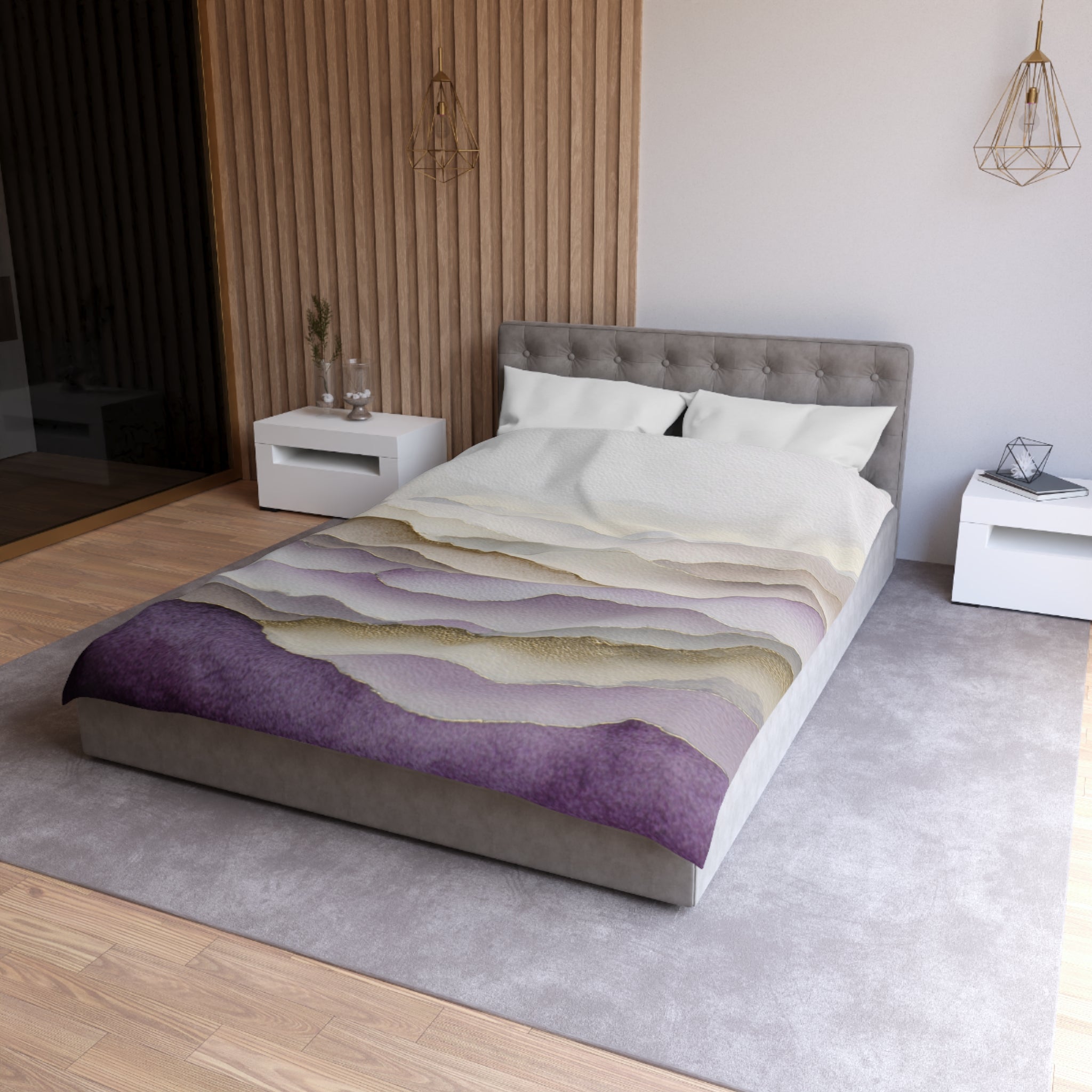 a modern bedroom with a large bed, a gray headboard, and a purple and white patterned bedspread. The room has a neutral color scheme with white walls and a wooden floor. There are two nightstands on either side of the bed, and a pendant light hangs above it.