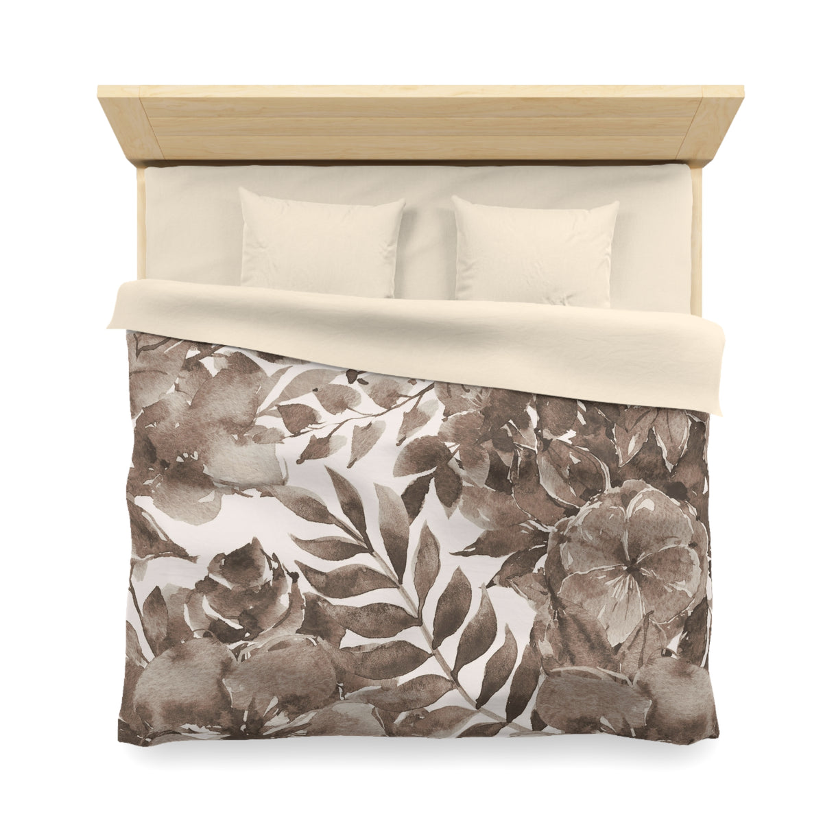 a neatly made bed with a floral print comforter and two pillows.