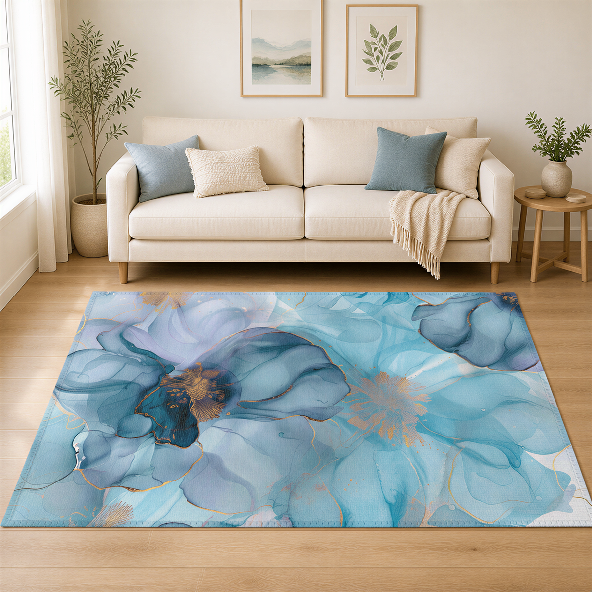 a living room with a large, colorful rug on the floor. The rug has a floral design in shades of blue and gold. The room includes a white sofa, a wooden side table, and a potted plant. There are also two framed pictures on the wall above the sofa.